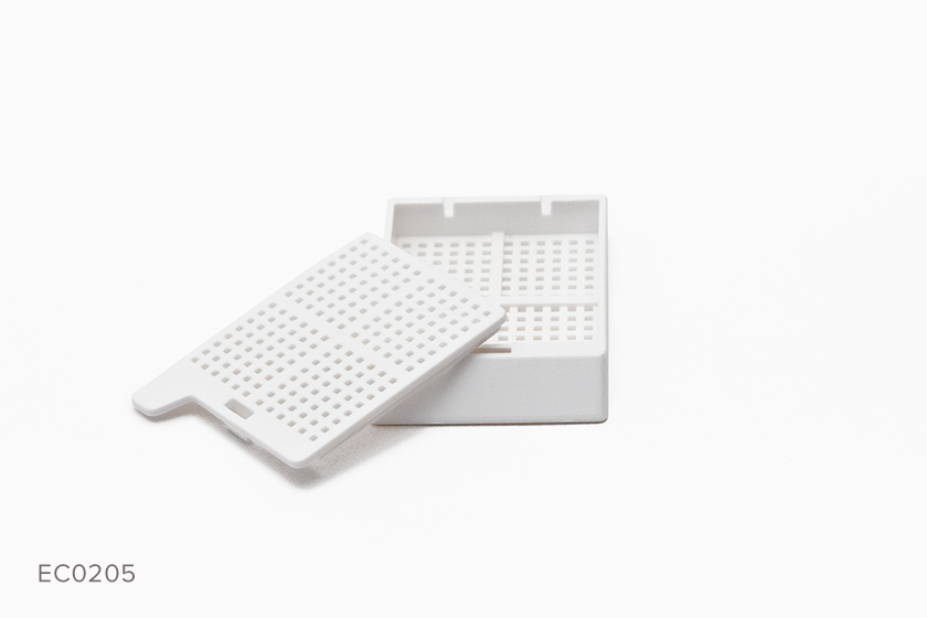 Typenex Medical Histology Biopsy Cassette in white (ECO0205). Back hinge, lid detached, .9x.9 mm.