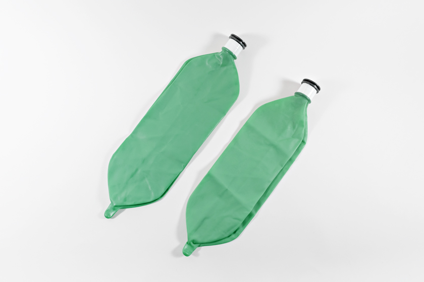 Two green anesthesia Reservoir Bags, laying flat.