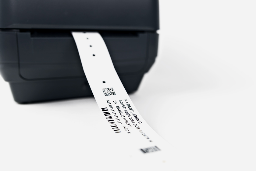 Typenex Medical's Symmetry SC Thermal hospital adult patient wristband being printed from a thermal printer.