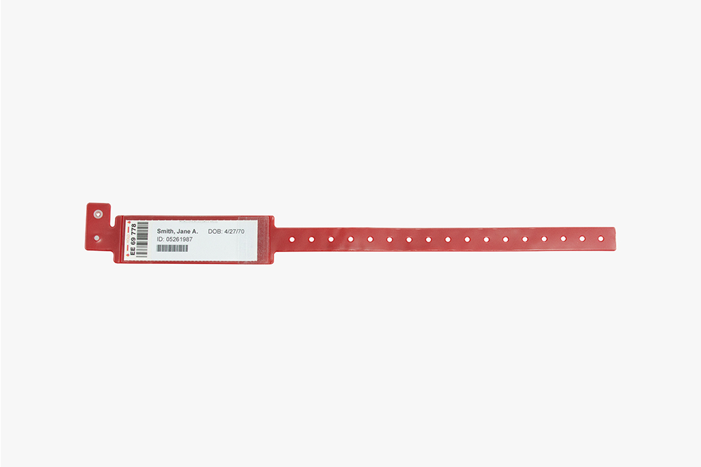 Red Typenex Medical Flexi 2.1 Patient Blood Band (FLX989) with plastic overlay and barcode symbology GS1-128.