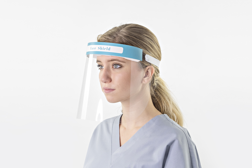 Typenex Medical PPE. Person wearing clear, full-length face shield affixed to blue foam headband.