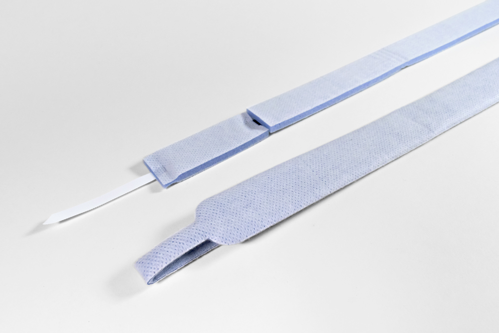 Adjustable two-piece tracheostomy tube patient neckband/collar with comfortable foam materials and Velcro hook tab.