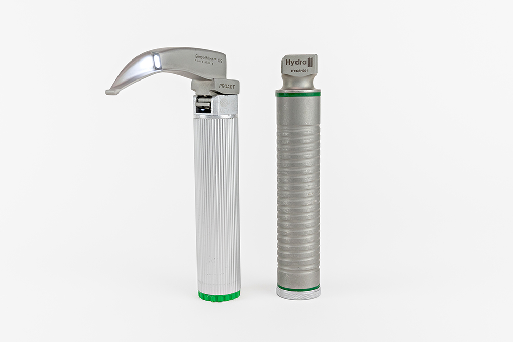 Disposable laryngoscope blade with disposable handle attached, shown with a separate reusable handle.