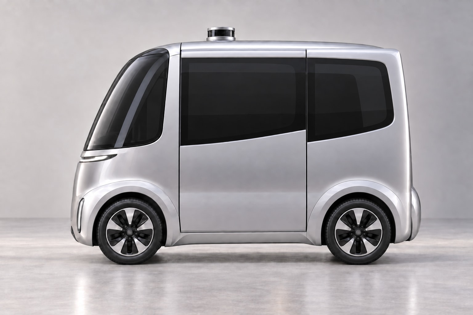 Full side view of the compact silver Pod 1 with its flush sliding door and four-wheel design