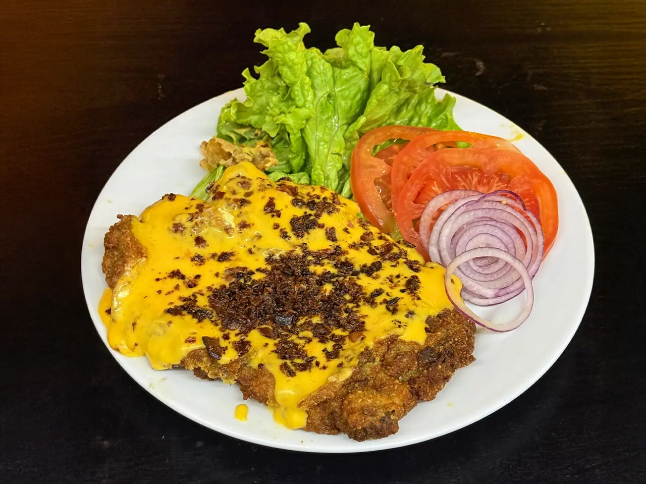 Milanesa con panceta y cheddar