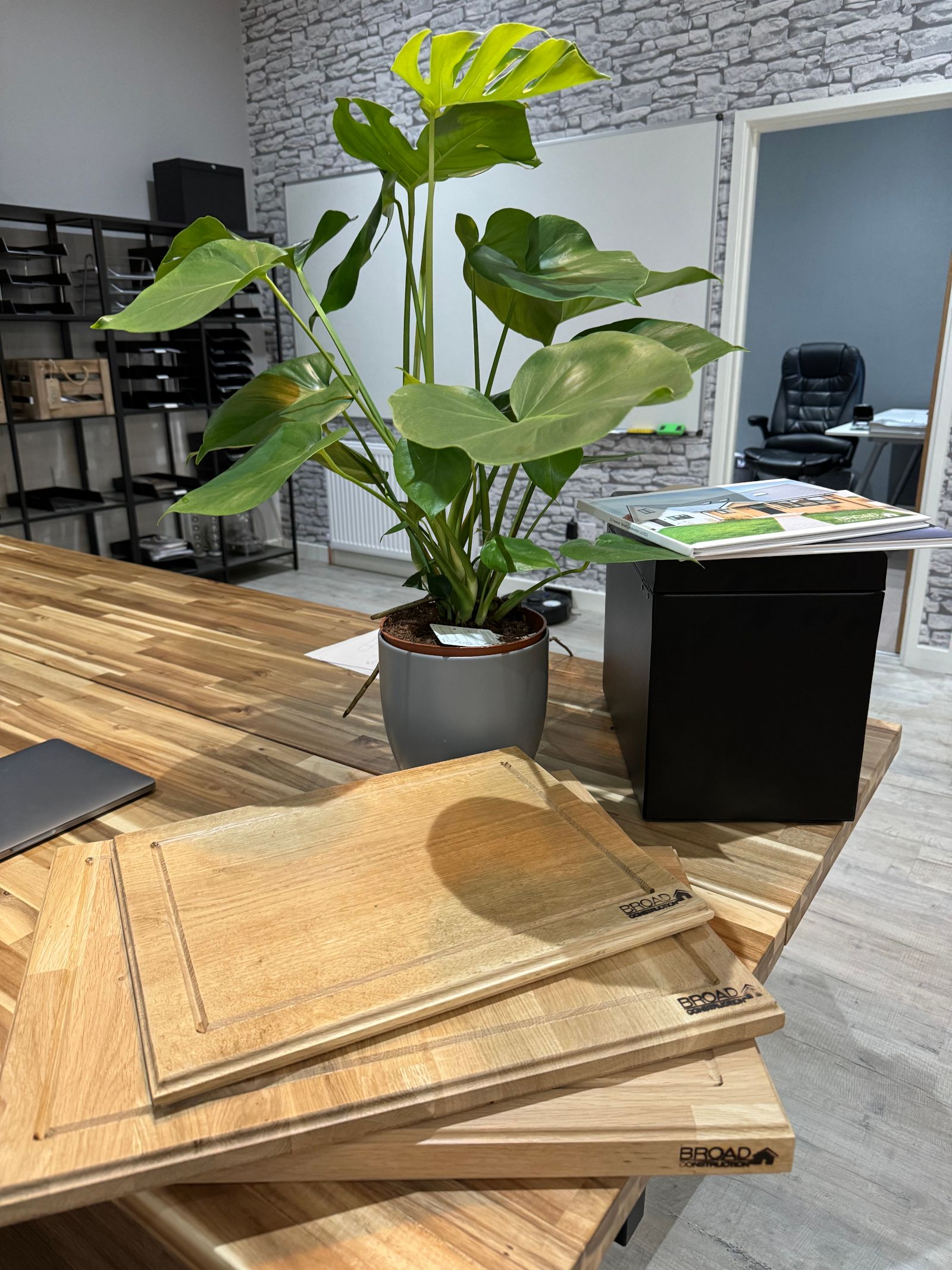 Wooden boards and a plant in broad construction offices