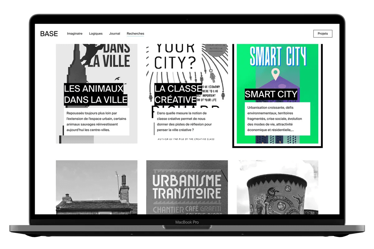 A laptop displays a webpage with various articles on urban topics, including "Smart City" with vibrant green and purple graphics.