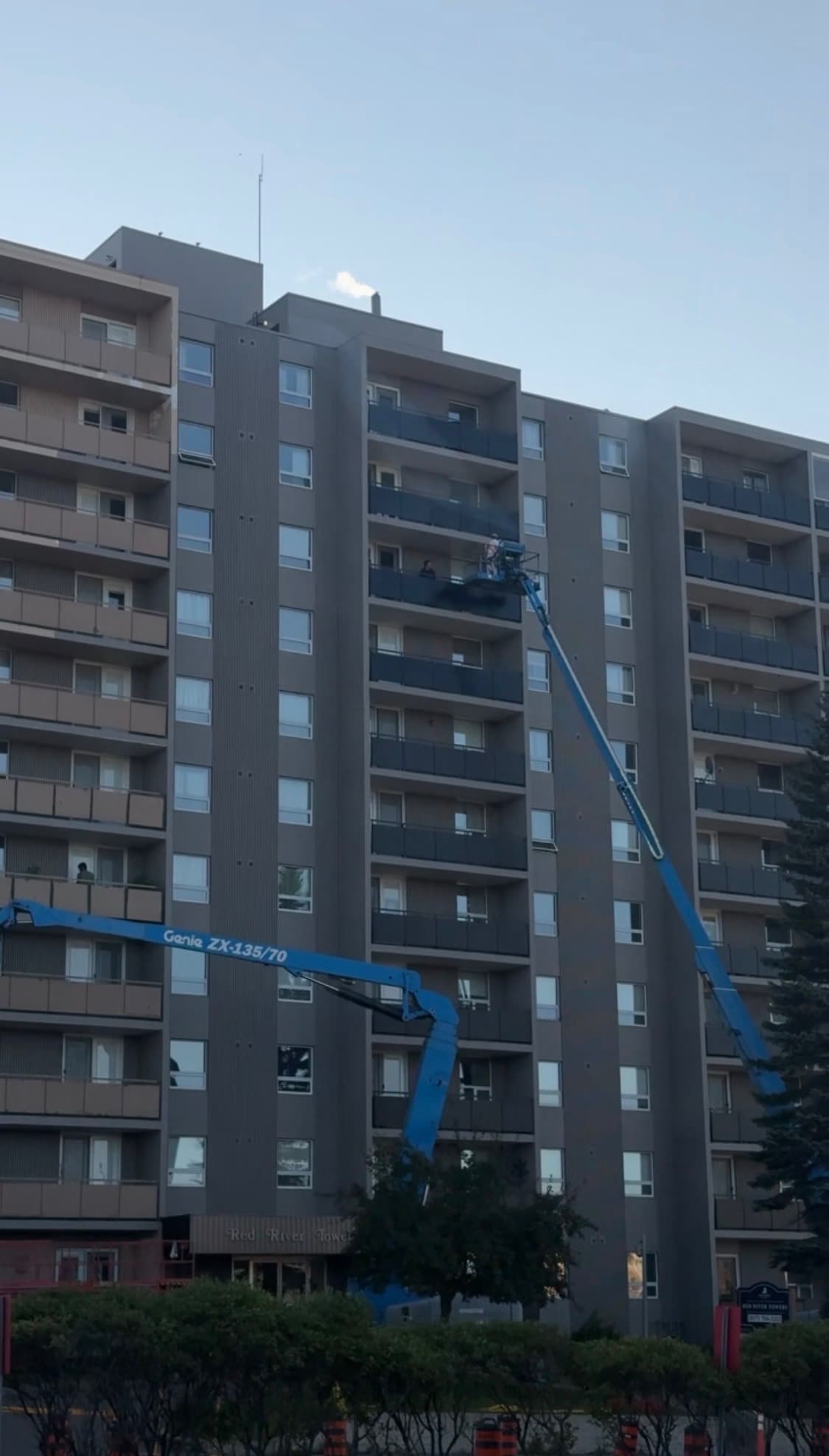 Painters using machines for heights