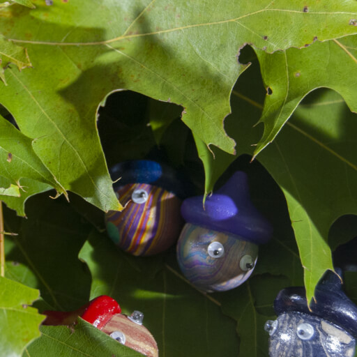 a set of small marbled acorns with googly eyes