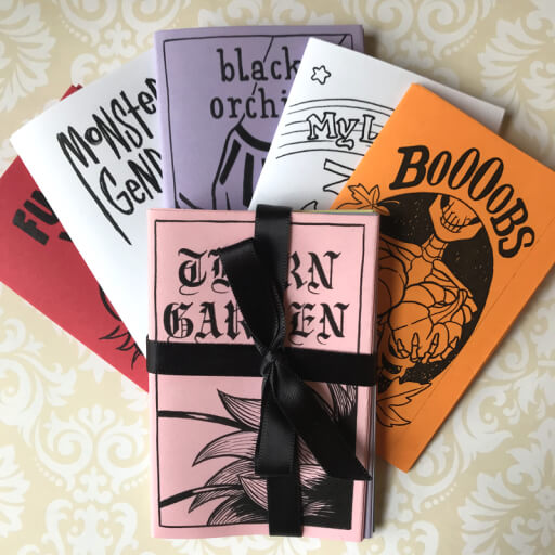 A spread of mini zines printed on assorted colorful paper
