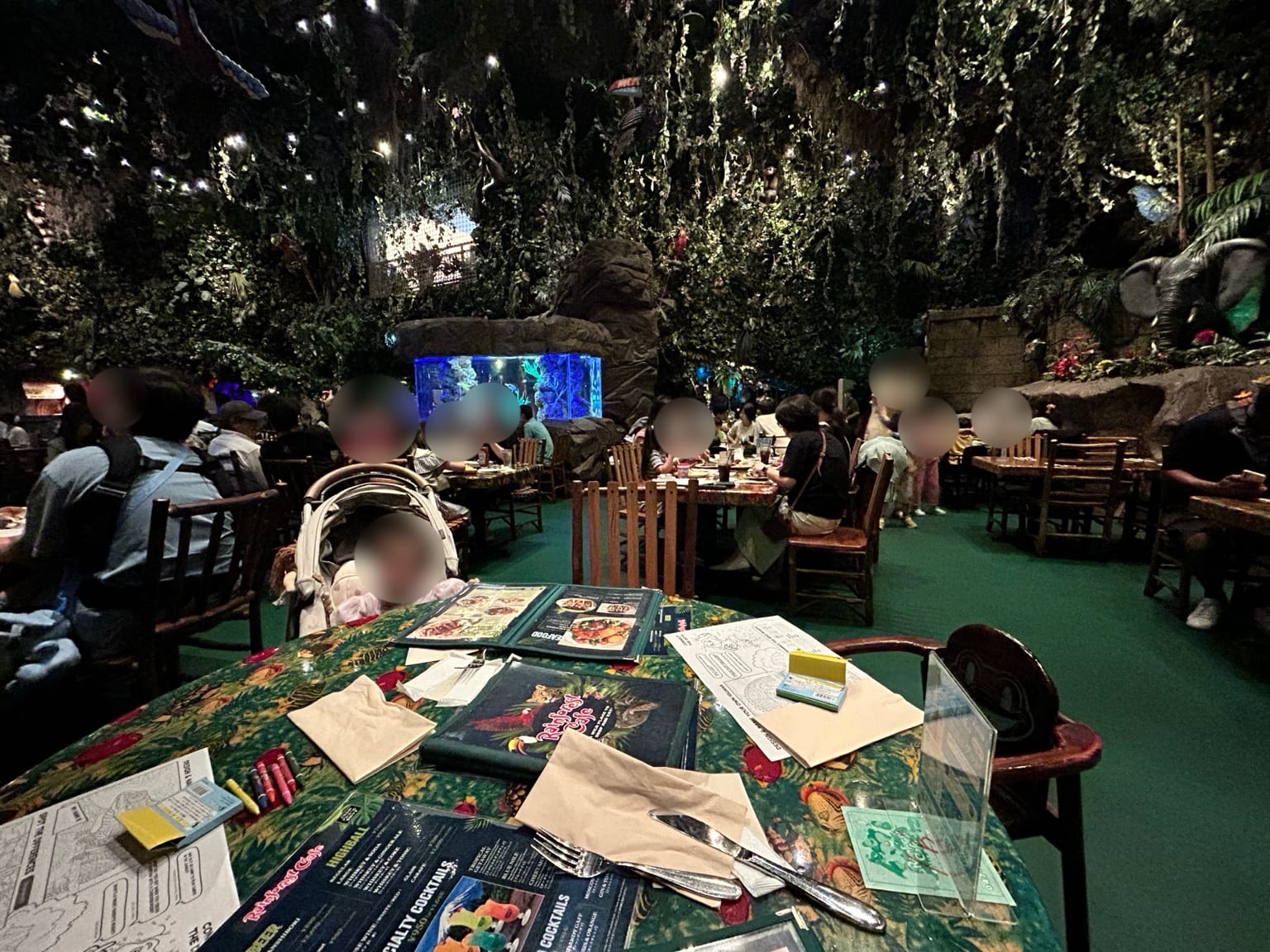 植物と岩の装飾に囲まれたレインフォレスト カフェの店内