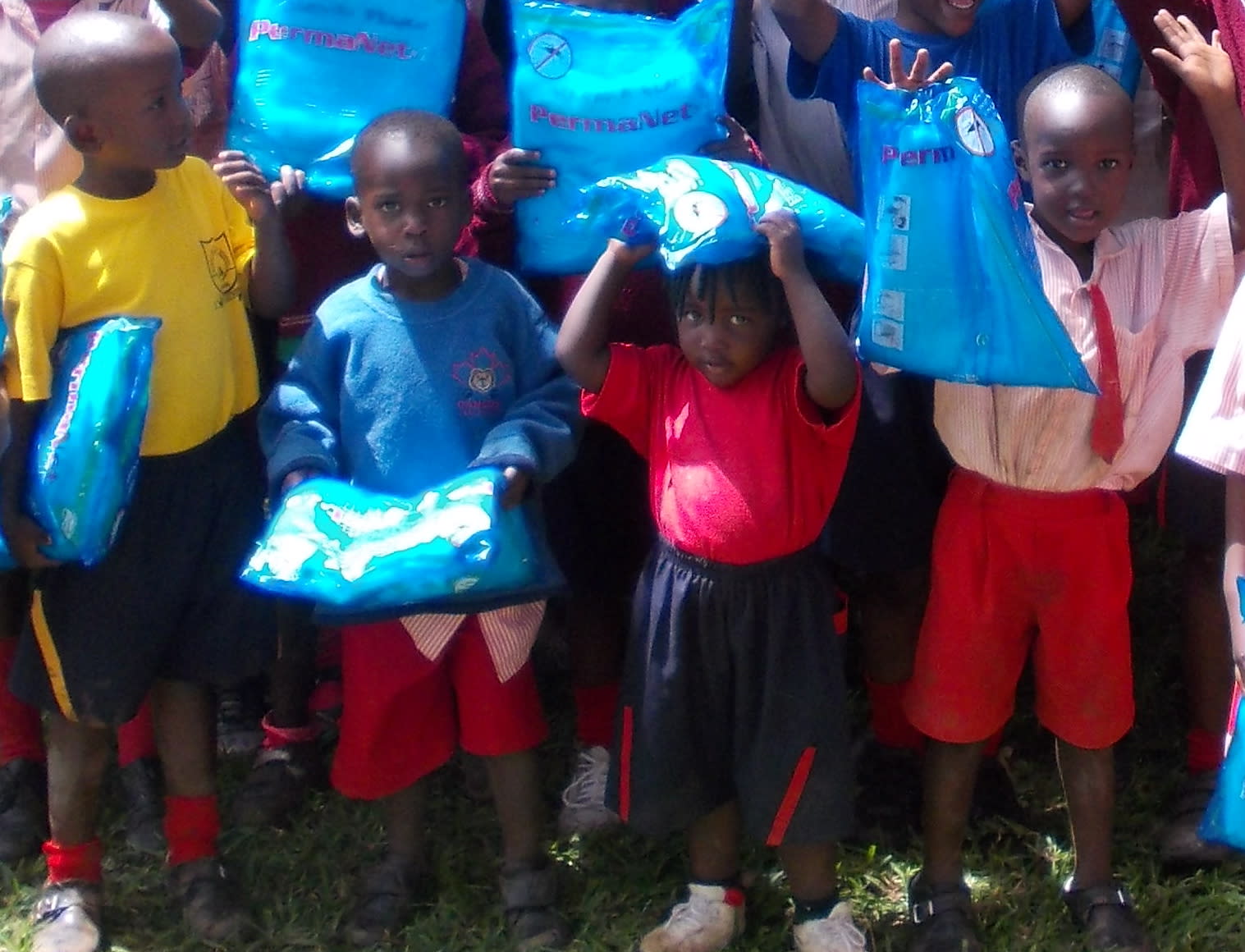 St. Thomas students with coins collected for mosquito nets