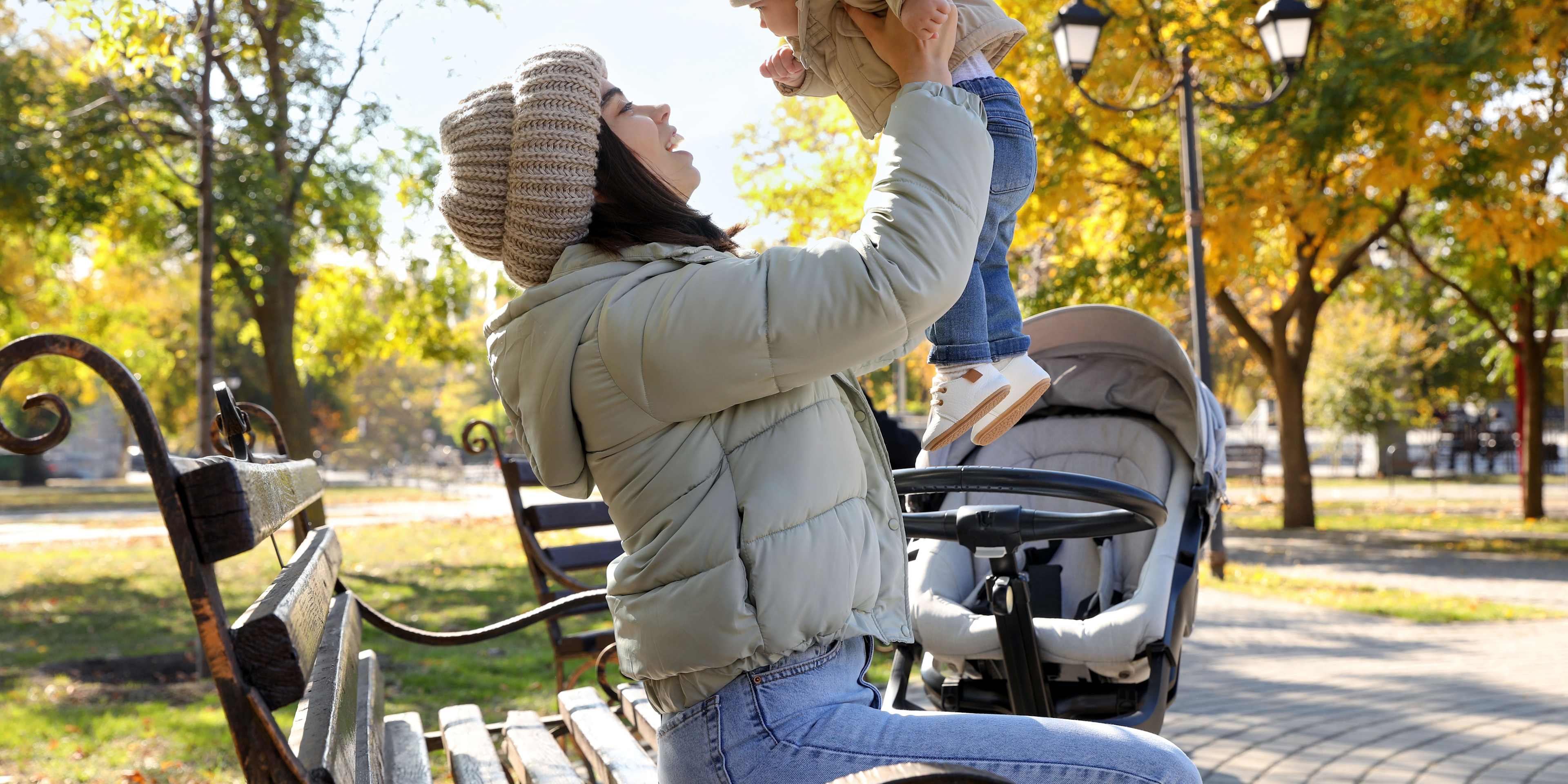 Woman Holding Baby in Park