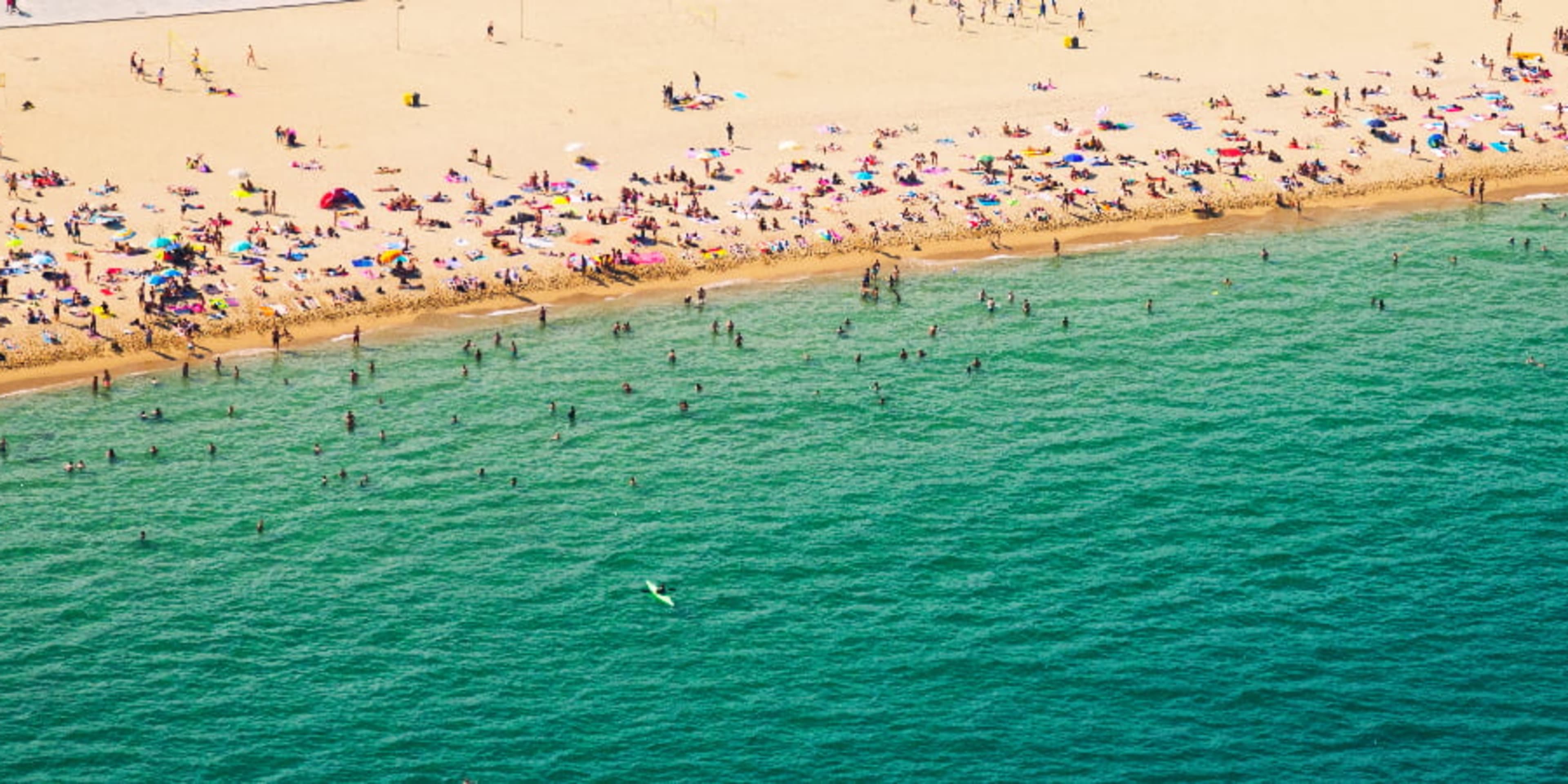 Crowds of tourists on a beach in Barcelona