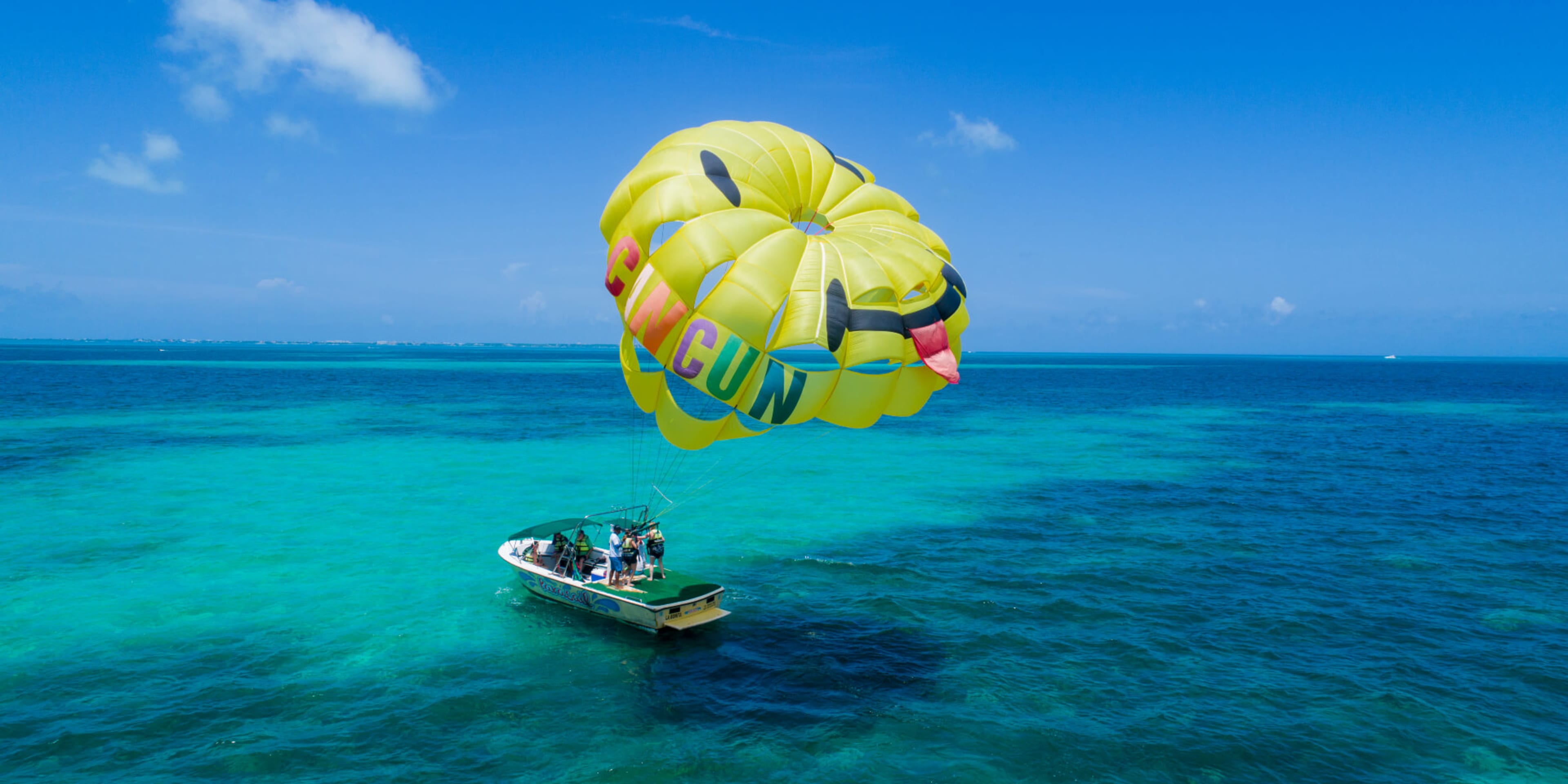 Speedboat with parasail inflated above it in Cancun