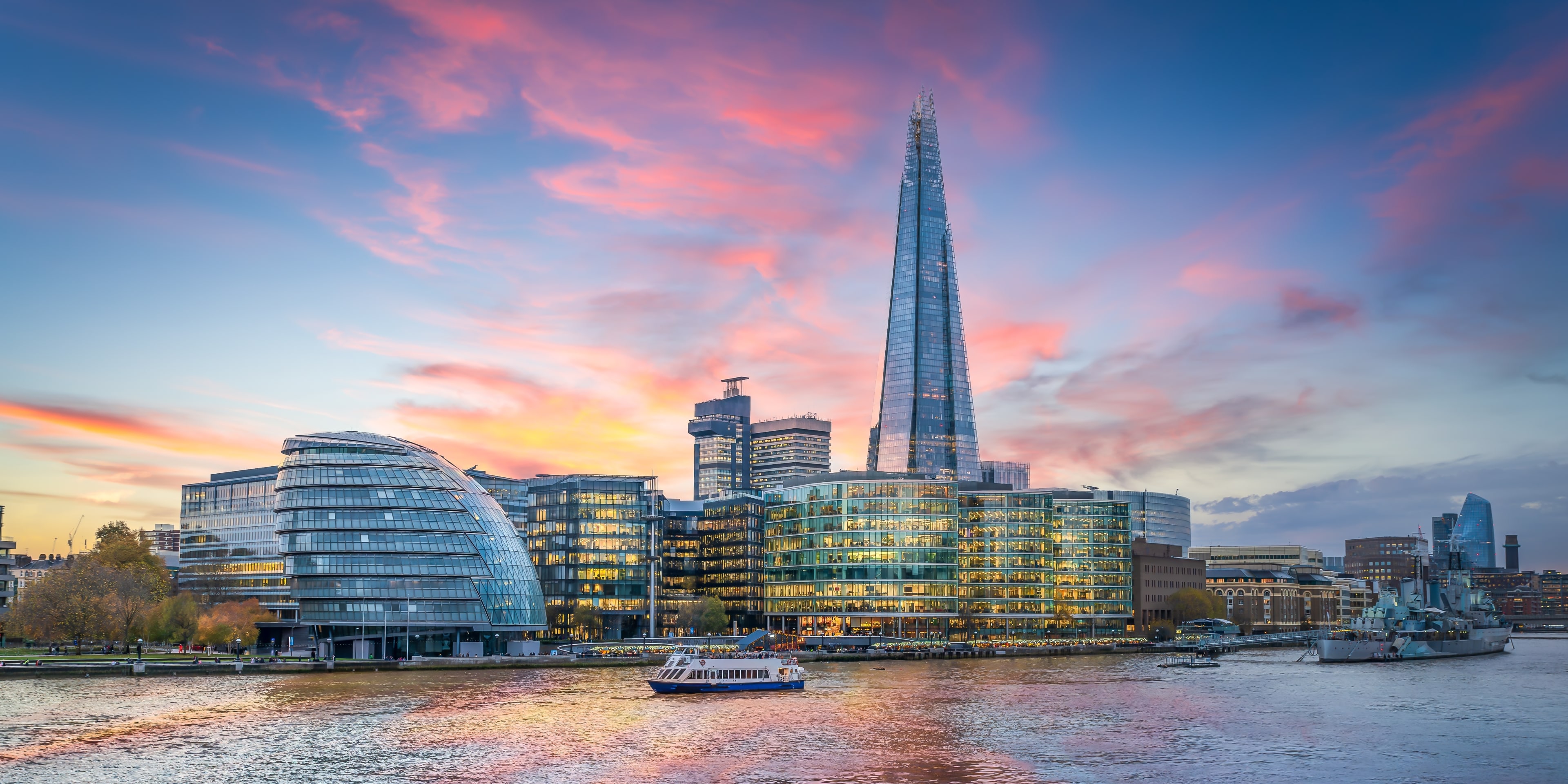 Panorama de l'horizon londonien, le long de la Tamise, lors d'une journée d'été ensoleillée.