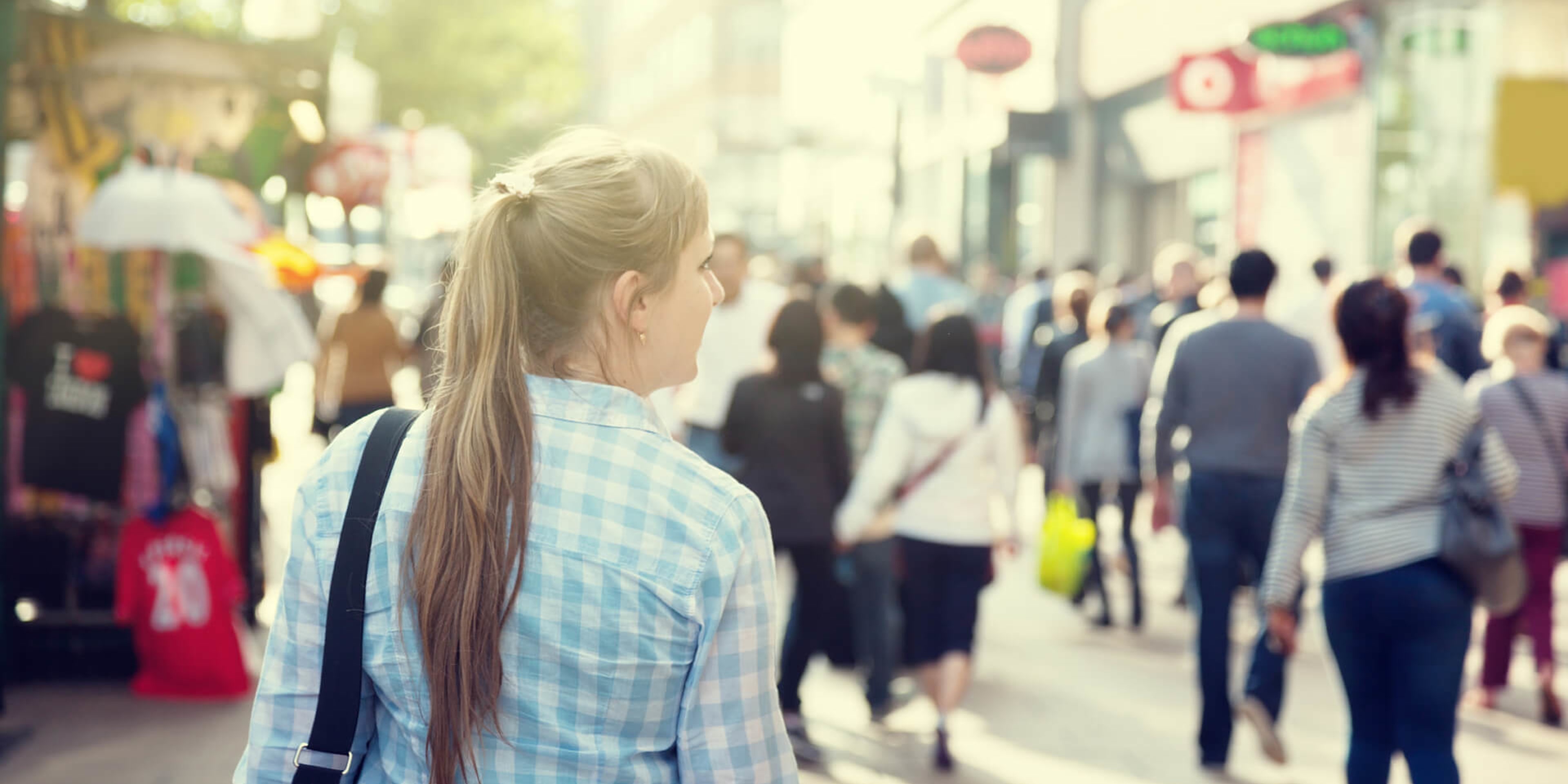 A woman walks alone through a busy London street
