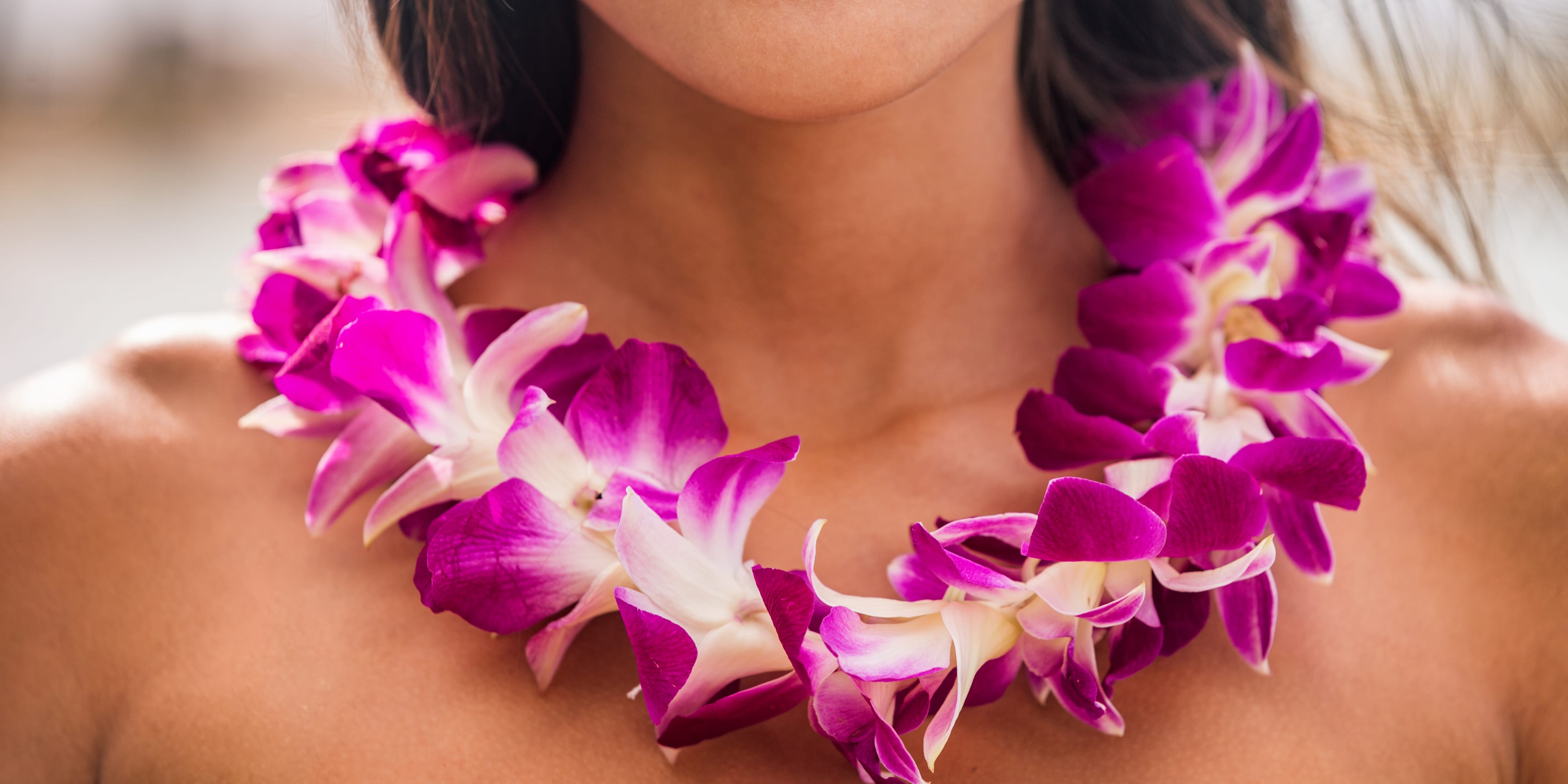 Smiling woman wearing a traditional Polynesian flower garland (lei)