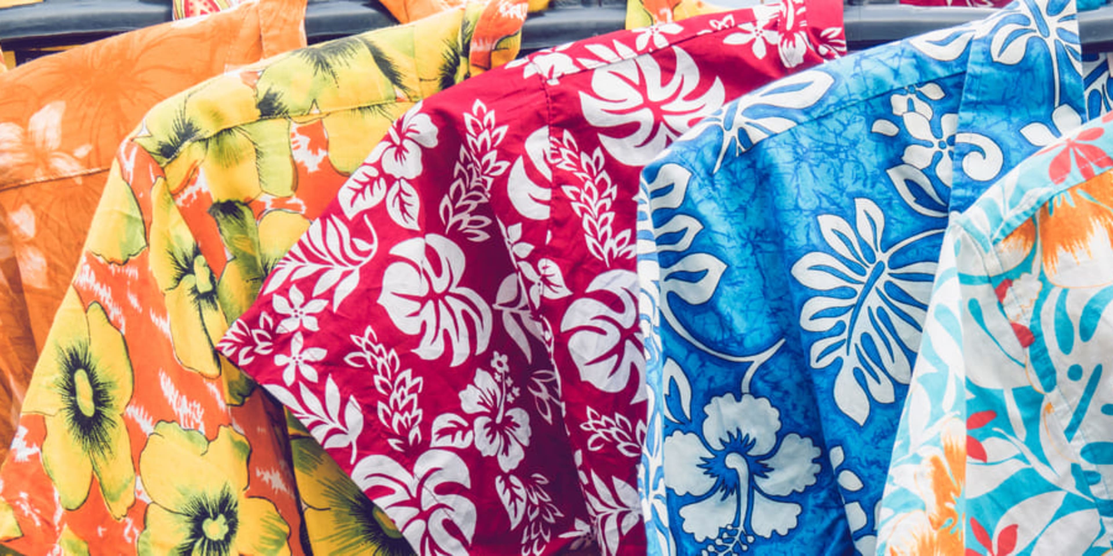Row of colorful Hawaiian shirts on a rail