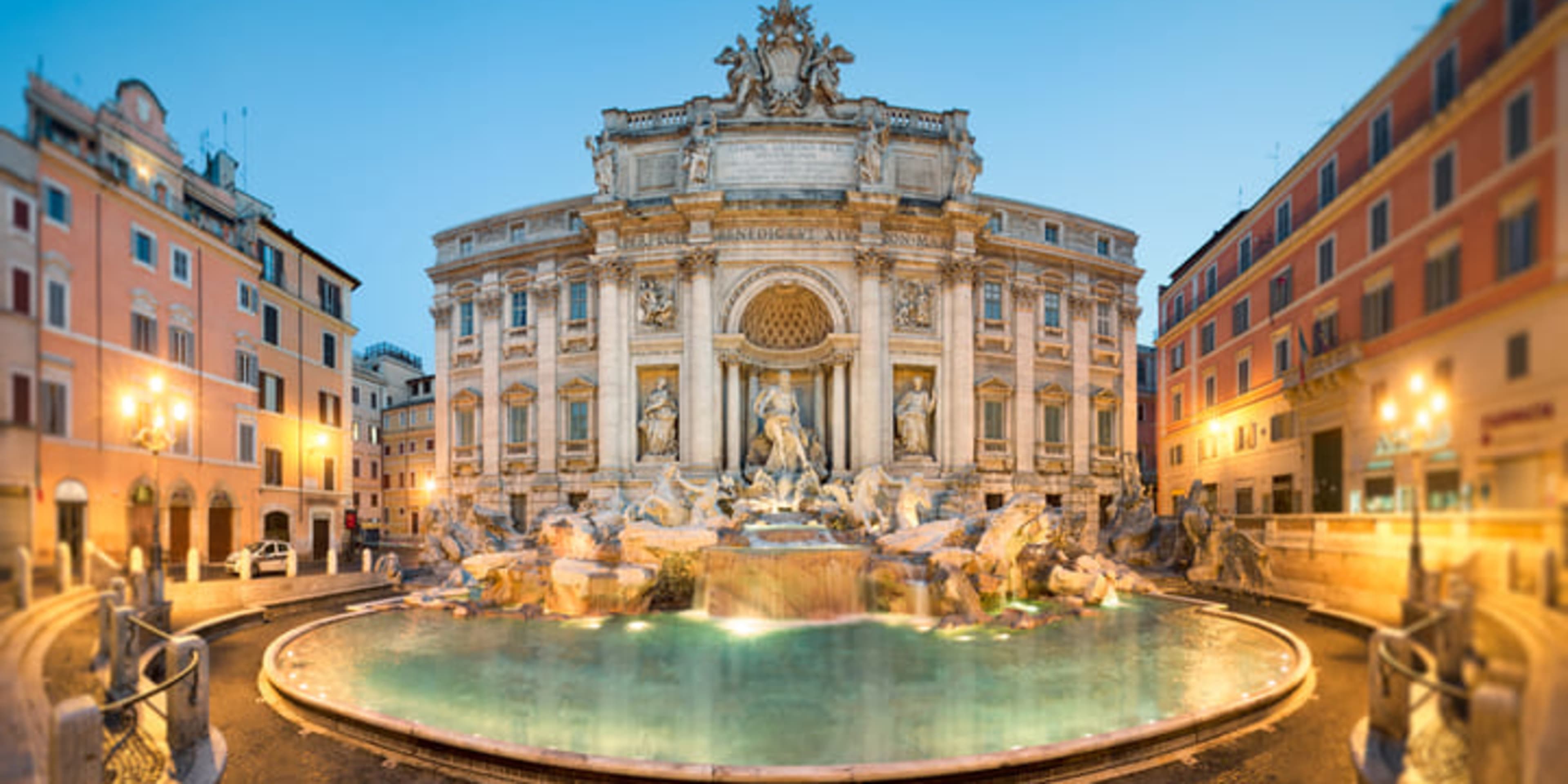 The Trevi Fountain in Rome, illuminated at dusk