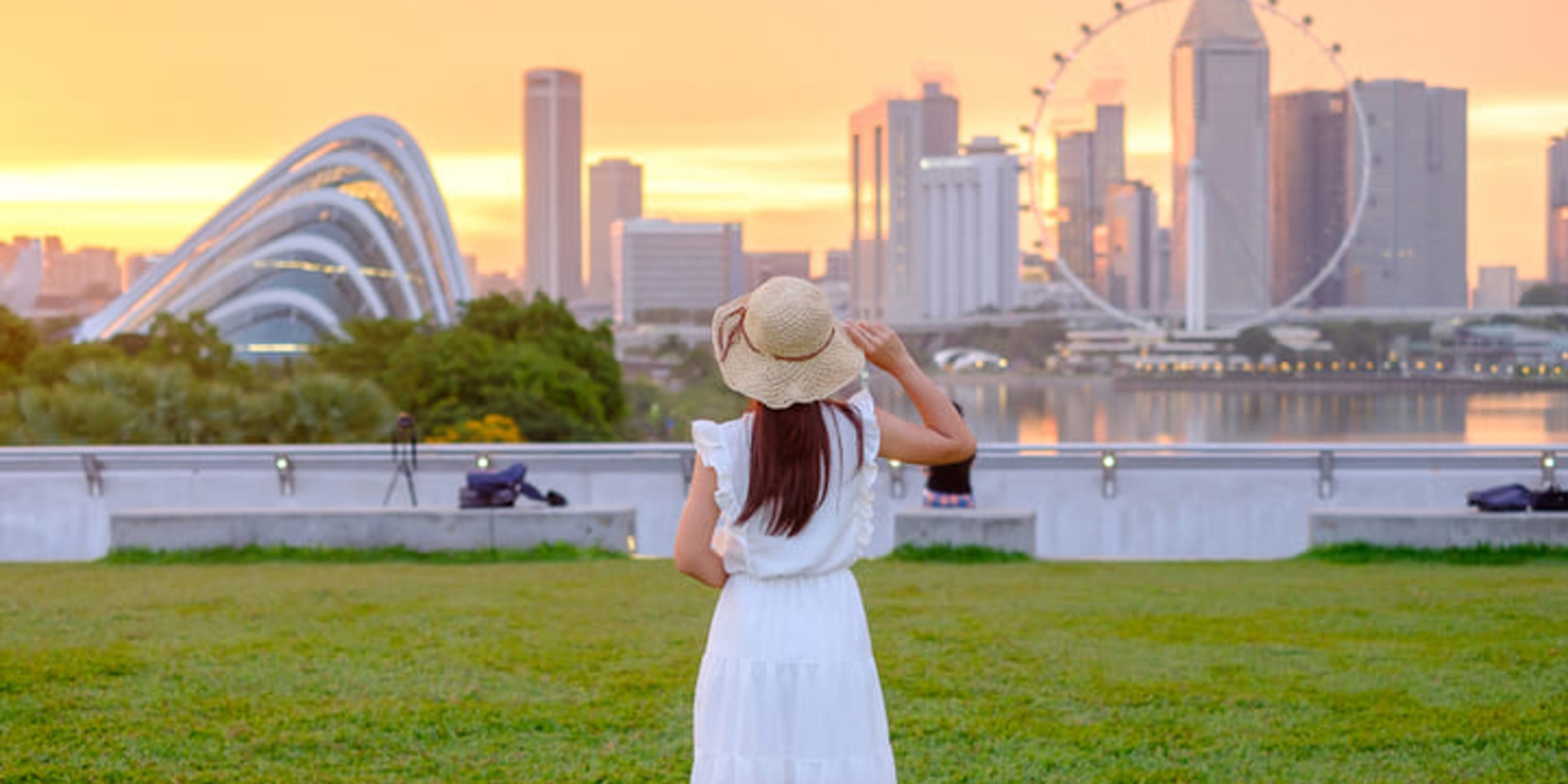 Woman looking across the water to the Singapore Flyer