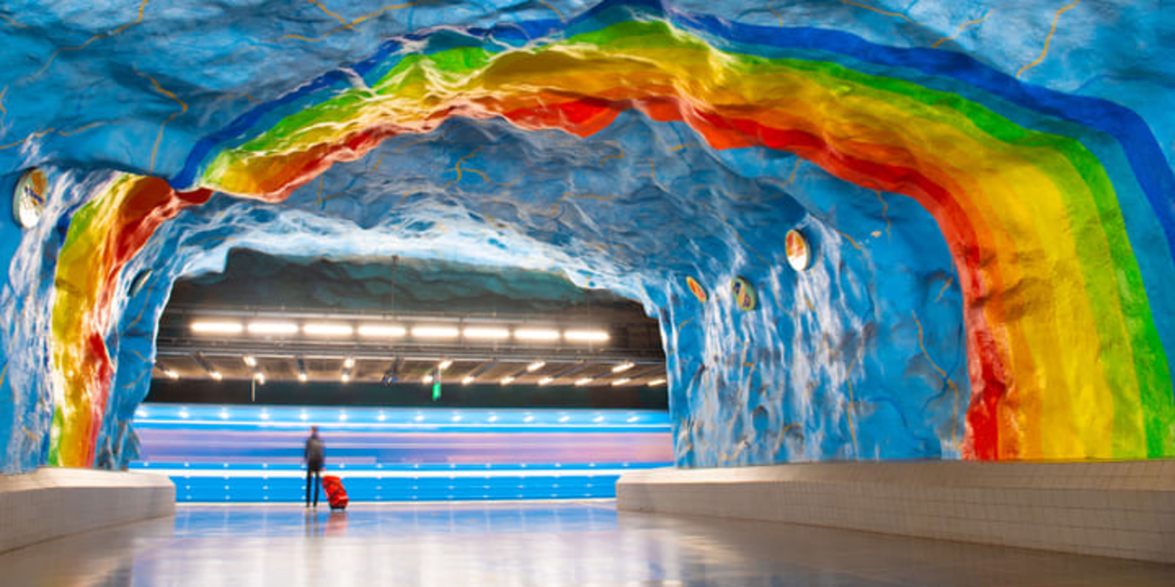 Art depicting rainbows and blue skies on the platform of Stockholm's Stadion metro station