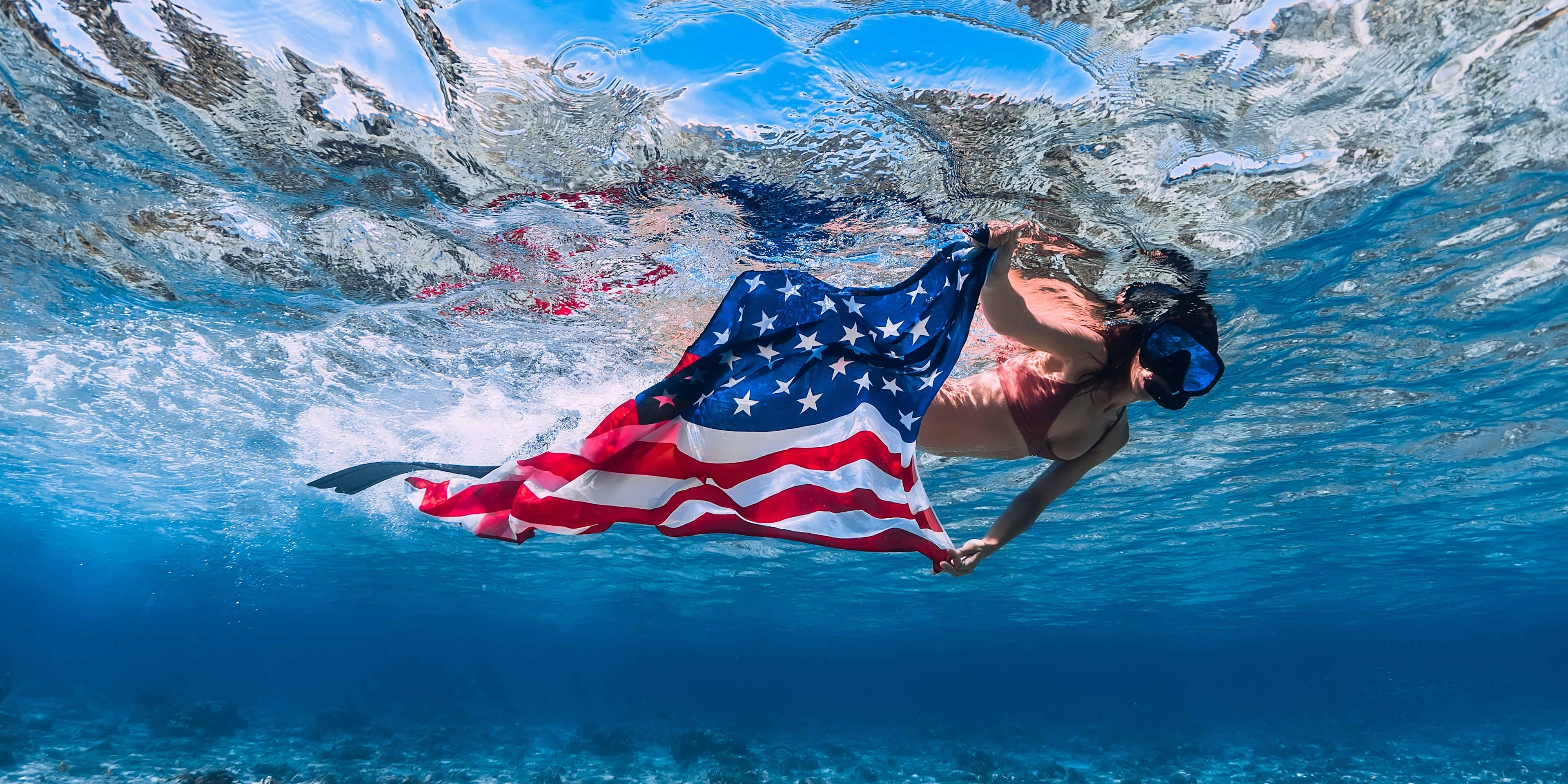 woman swimming with an american flag 