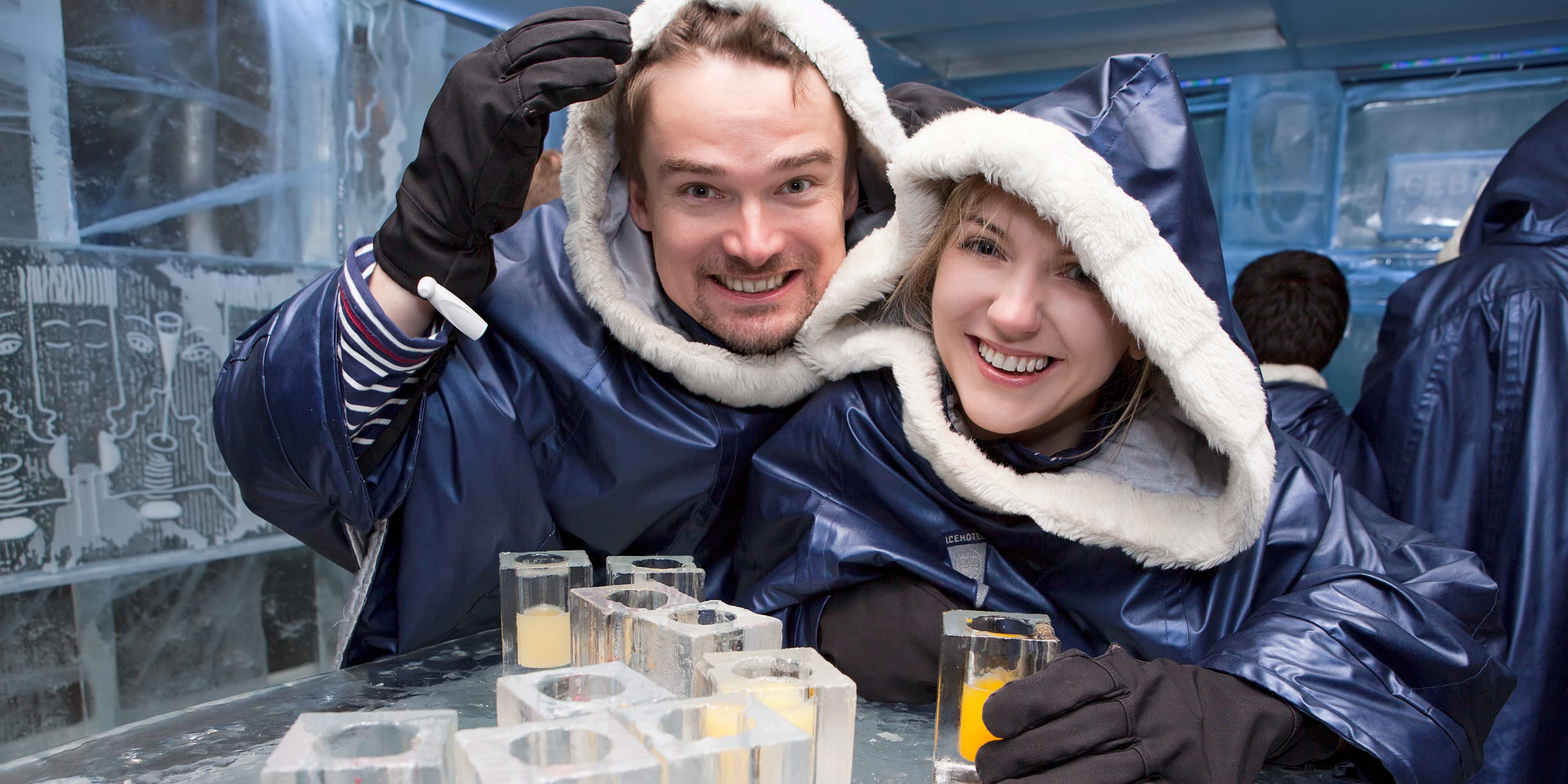 couple enjoying a chilled drink in an ice bar