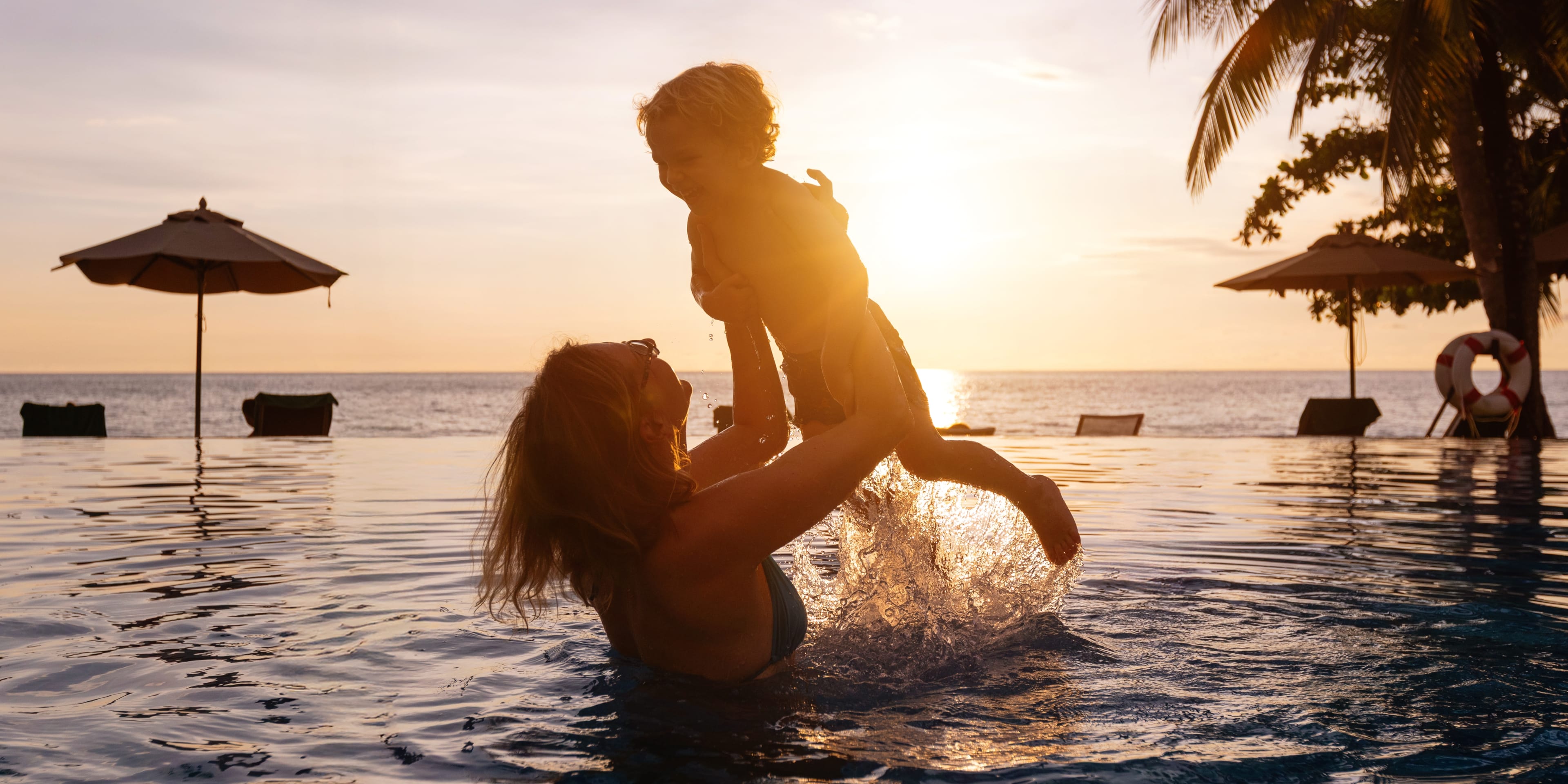 mother and her baby on holiday in a pool