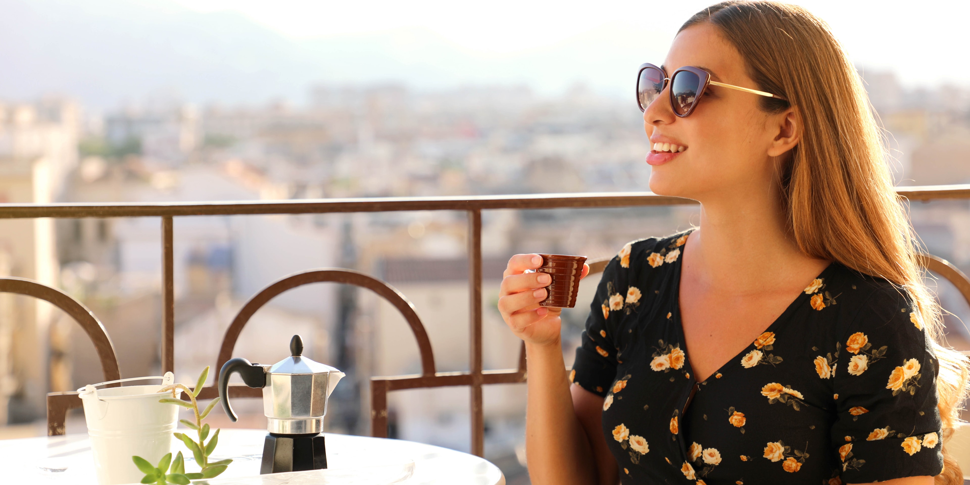 Woman enjoying a glass of wine at sunset in Rome