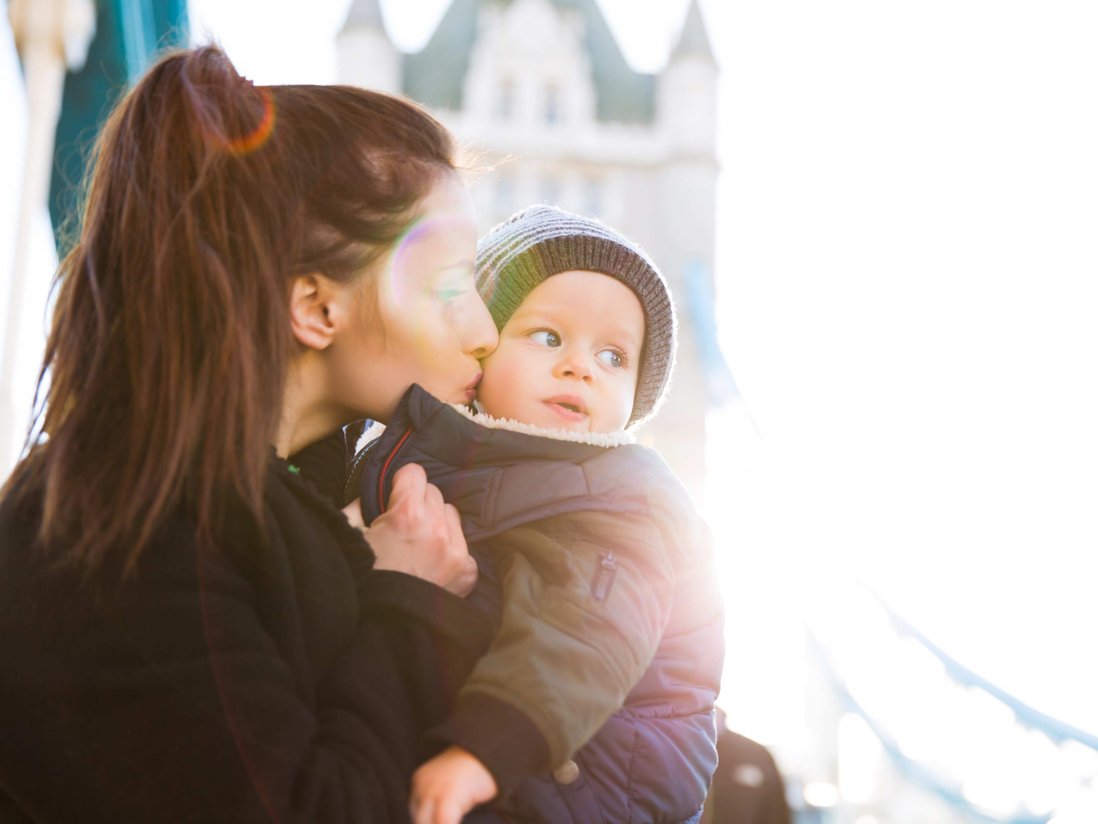 mother kissing her baby in london