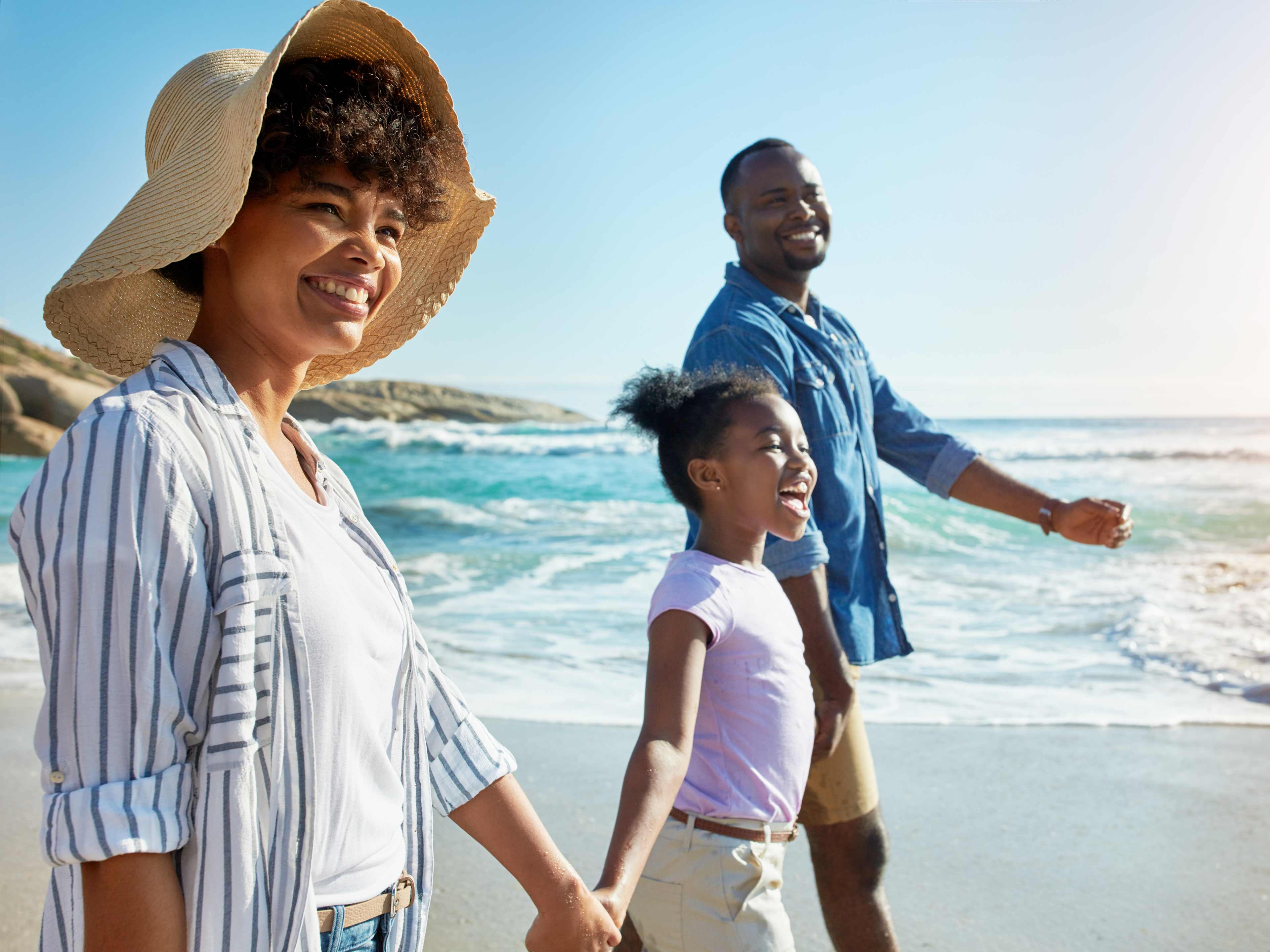 family enjoying a walk on the beach