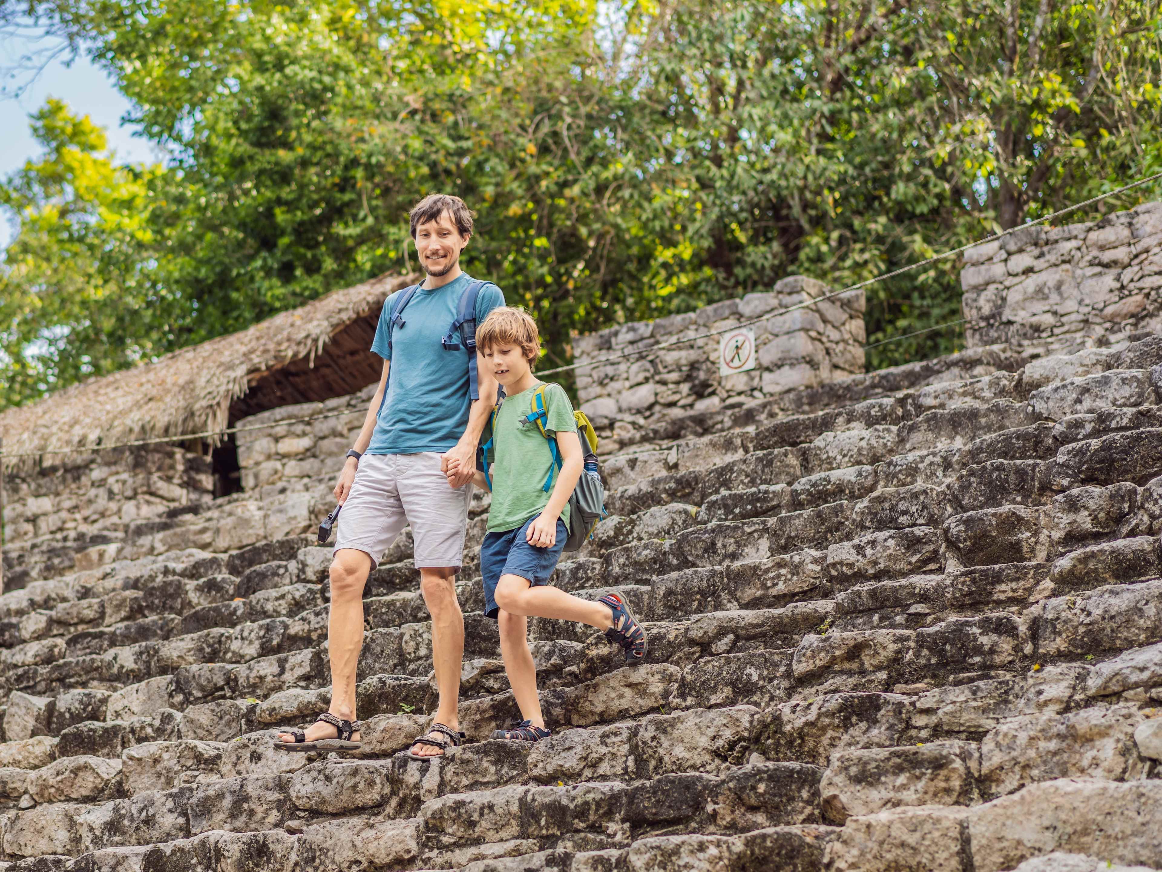 Father and Son Walking Around Mayan Ruins
