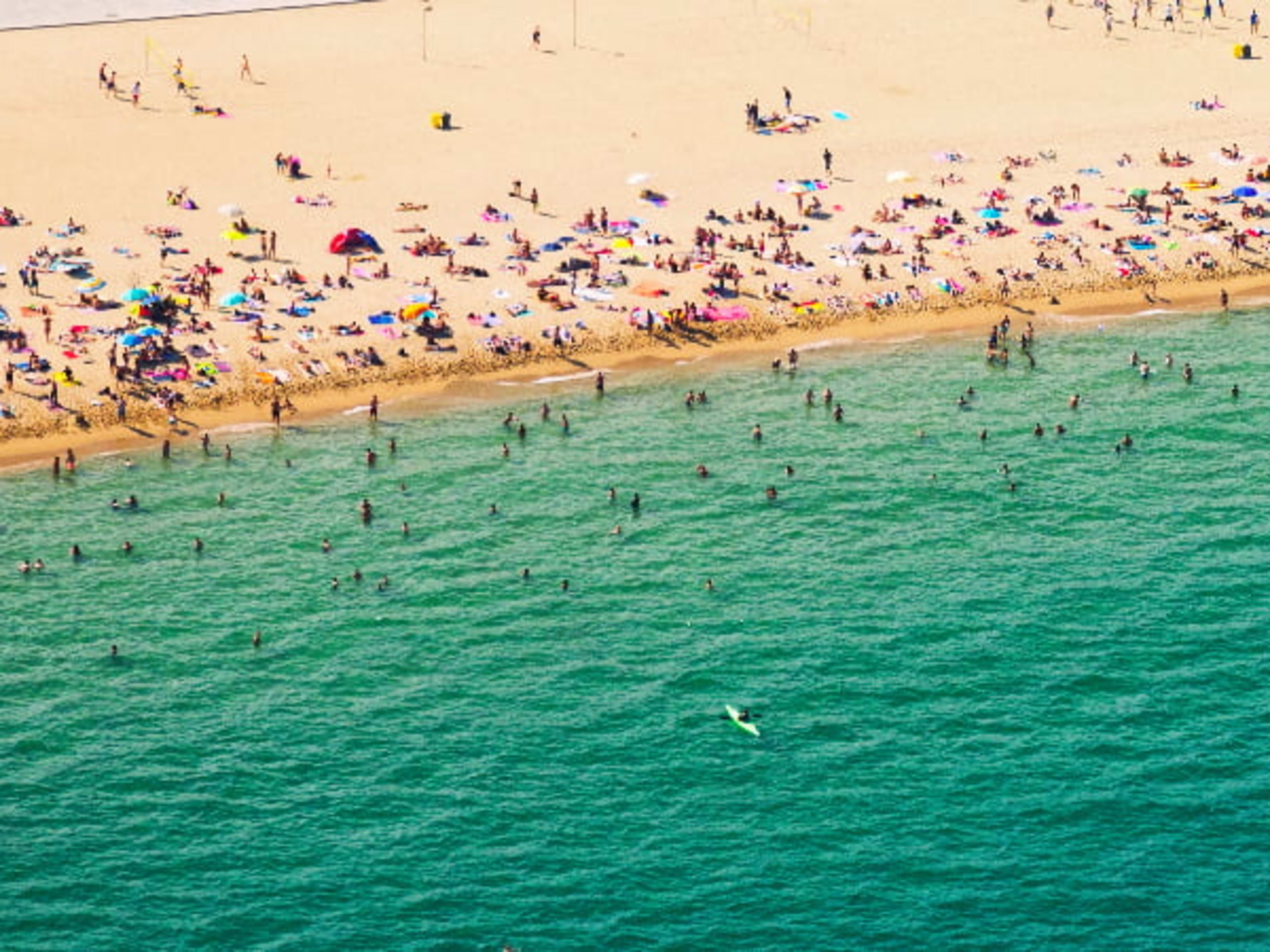 Crowds of tourists on a beach in Barcelona