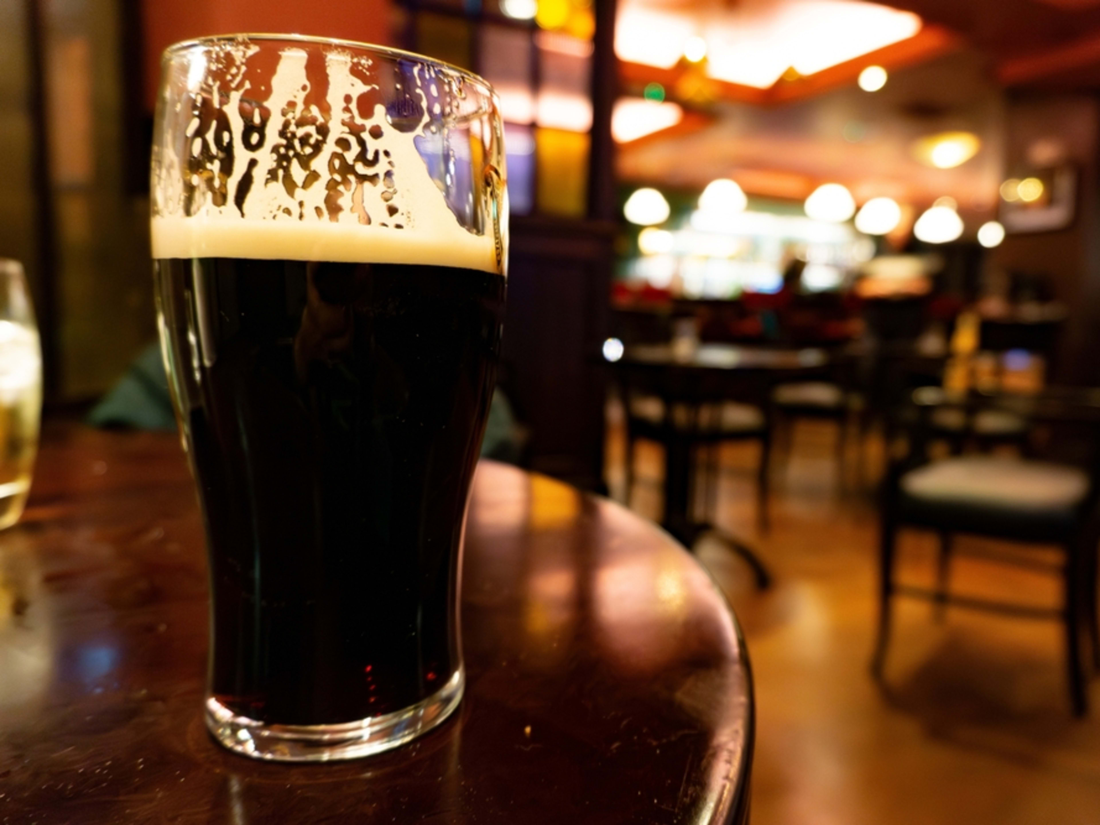 Pinta de cerveza negra en la mesa de un pub irlandés. Datos curiosos de la cerveza Guinness.