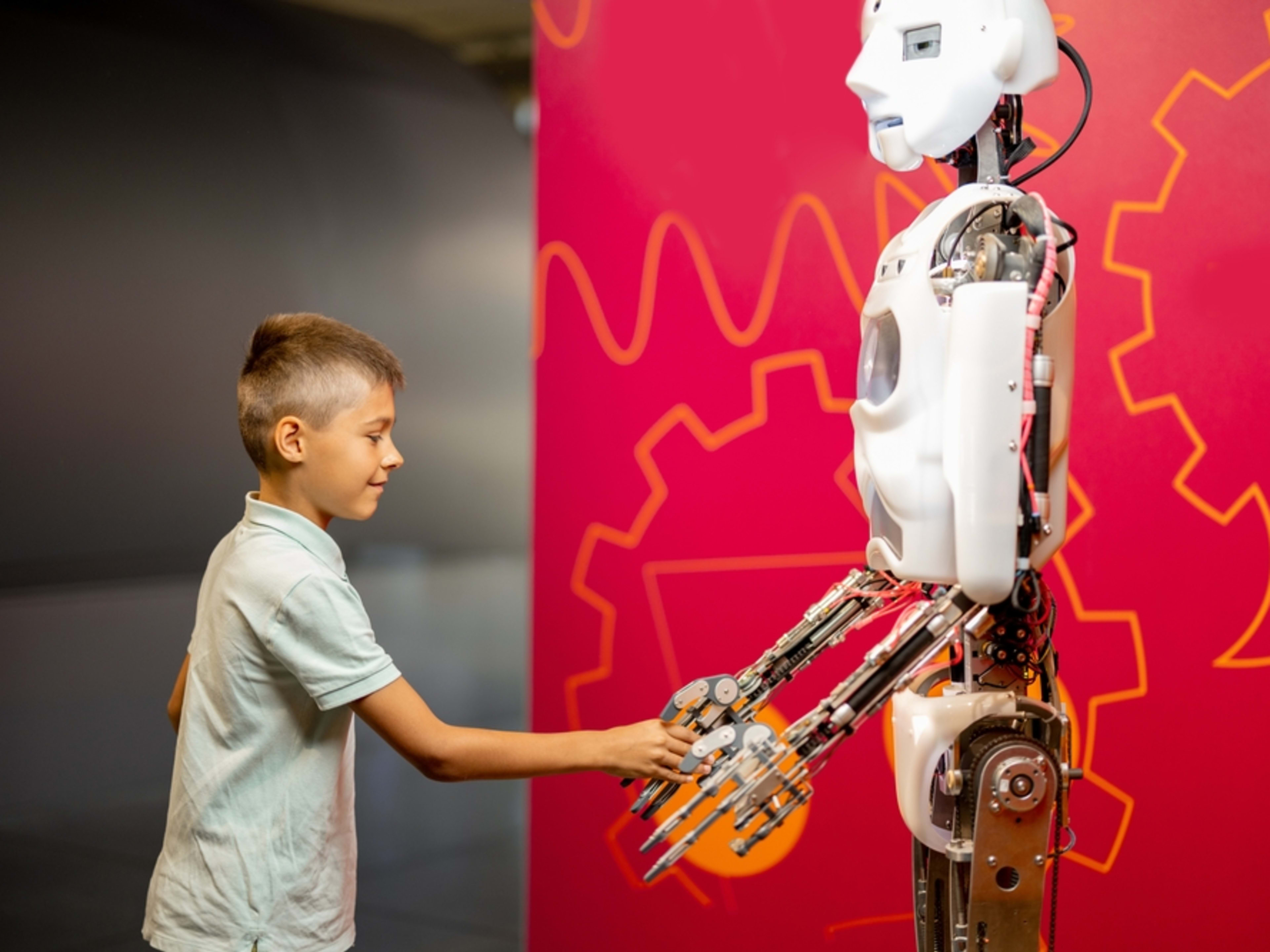 Child meeting a robot in a science museum
