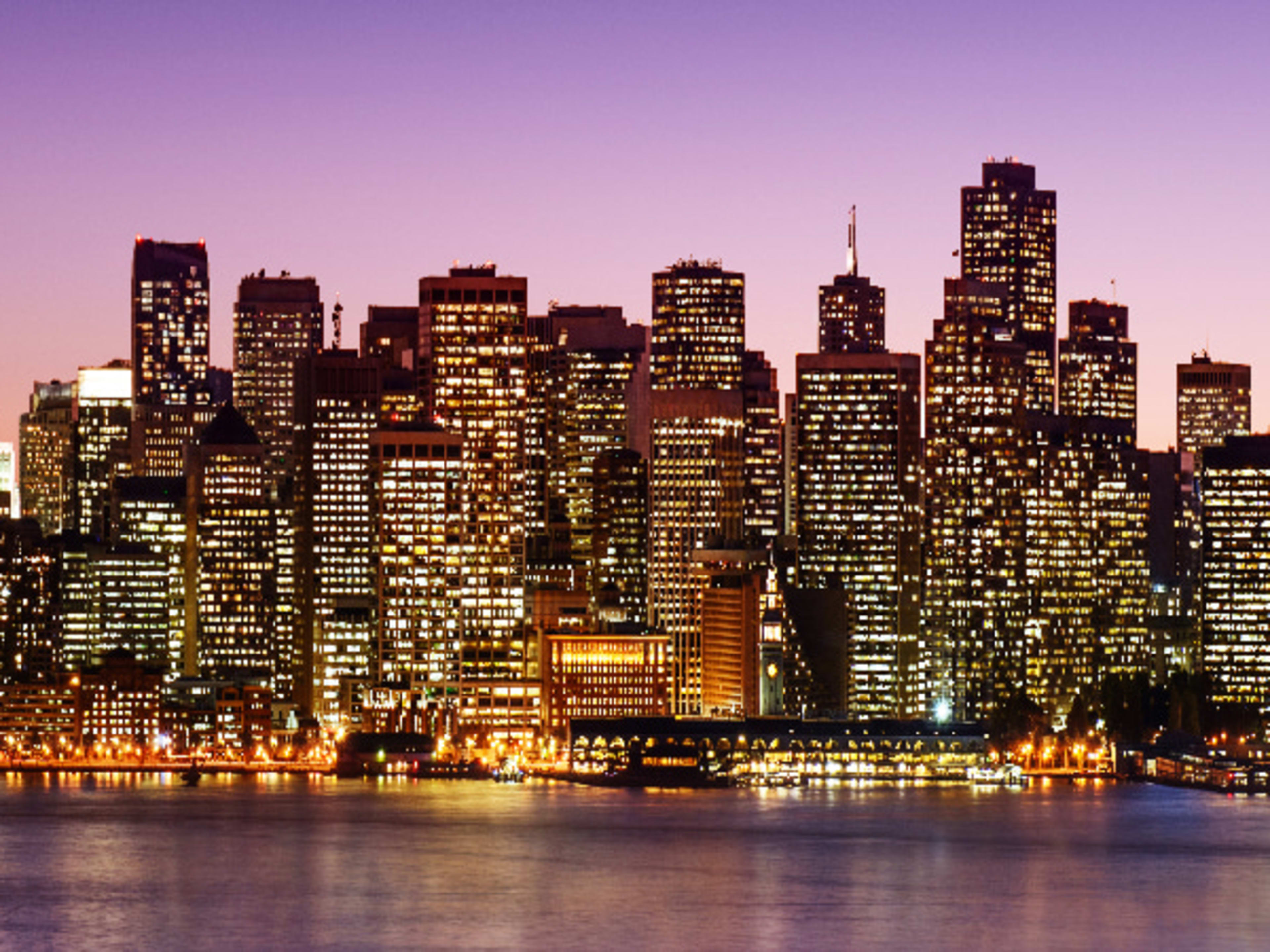 San Francisco skyline and the Golden Gate Bridge illuminated at night