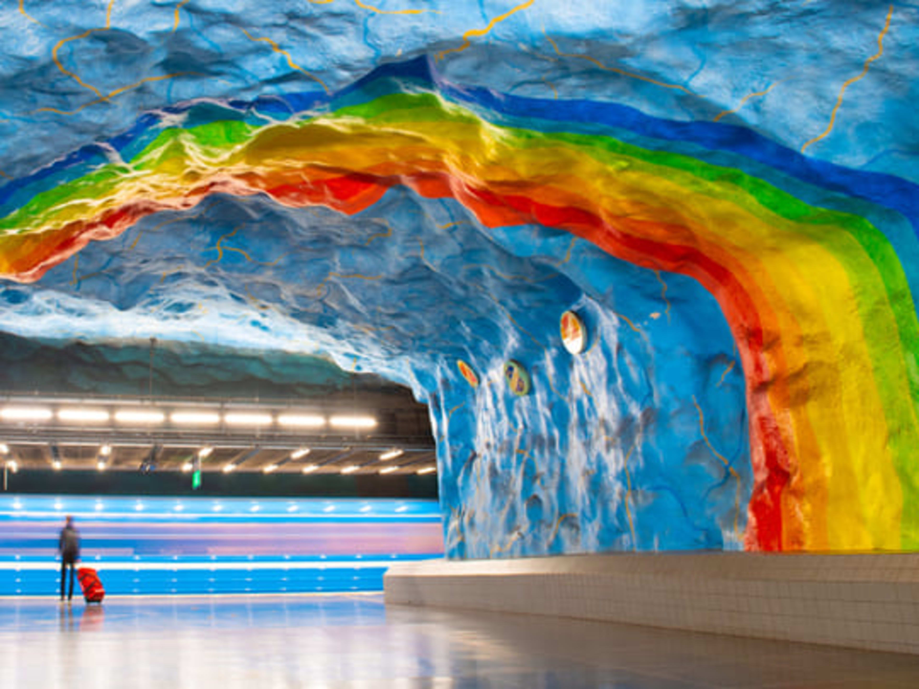 Art depicting rainbows and blue skies on the platform of Stockholm's Stadion metro station