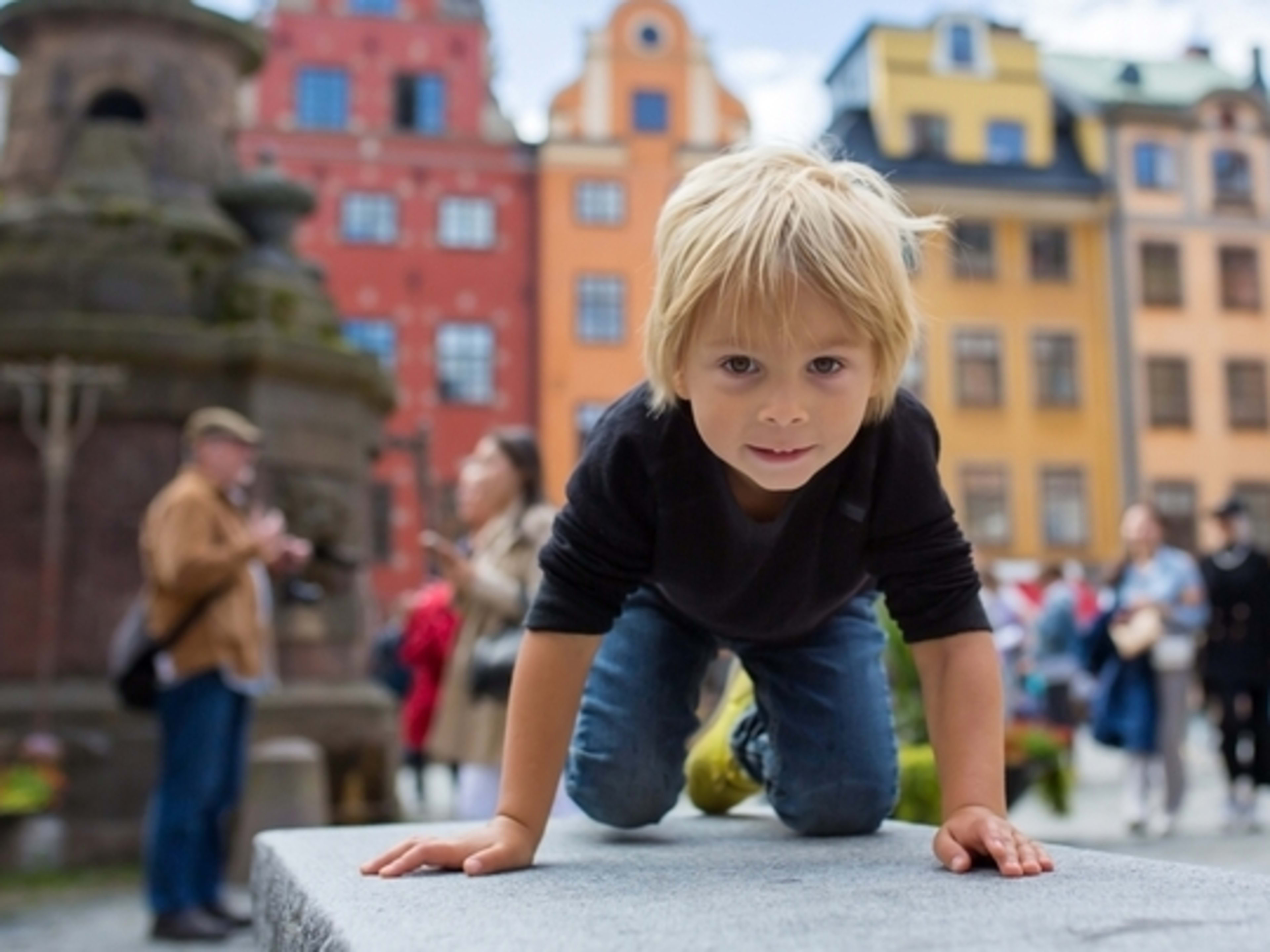 Little boy exploring Stortorget square in Stockholm's old town