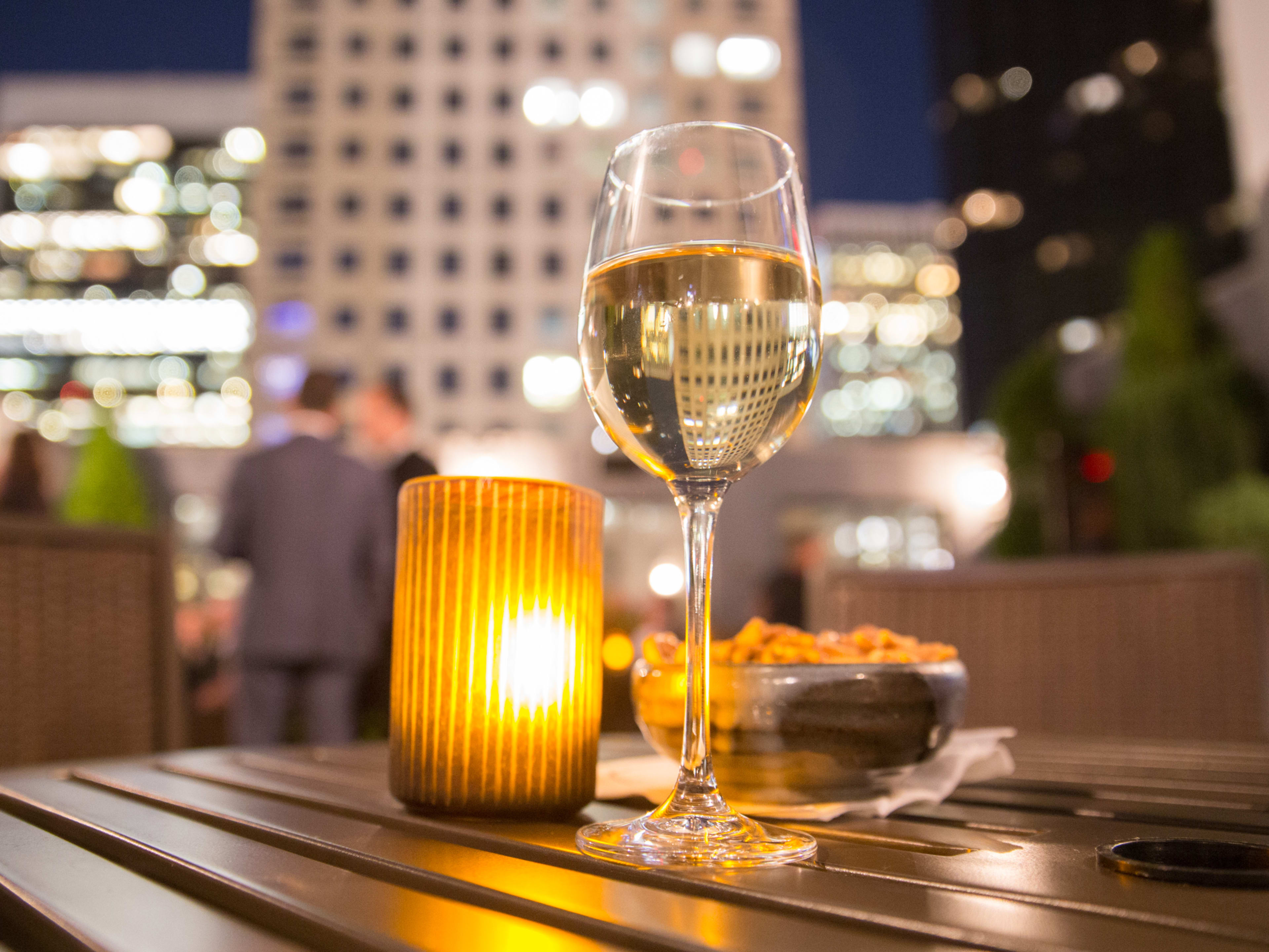 glass of wine on a rooftop bar in nyc