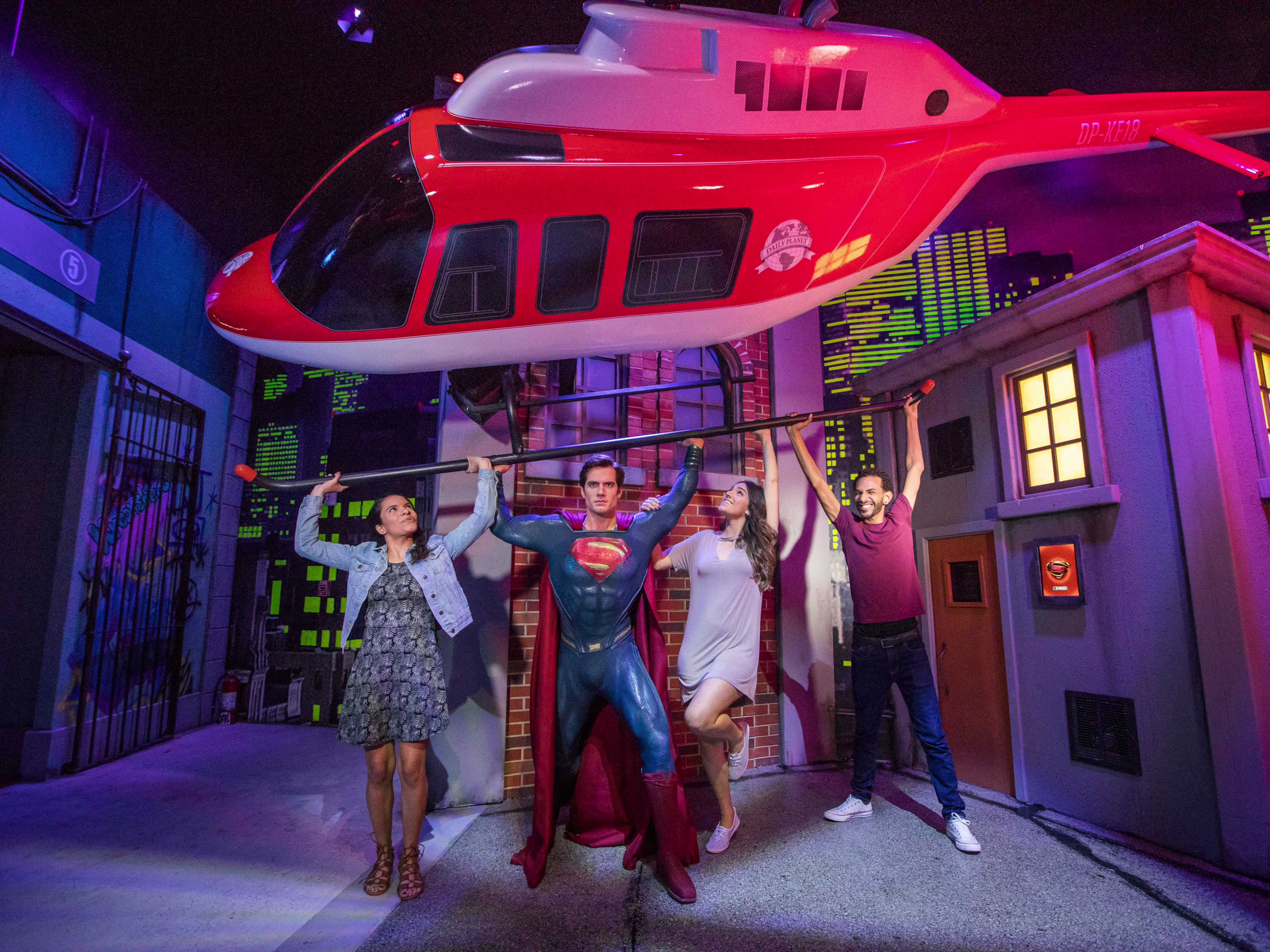 people hanging out with superman in madame tussauds