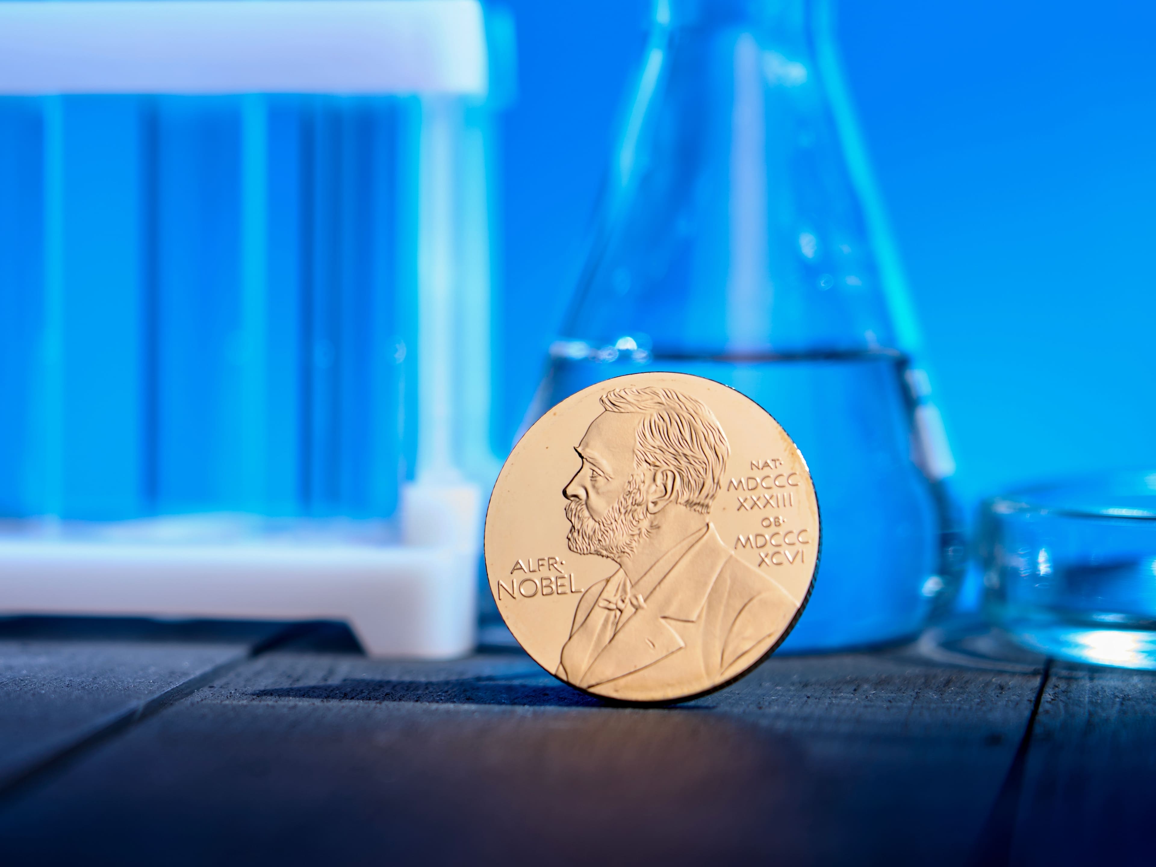 a nobel peace prize in front of a chemist's set