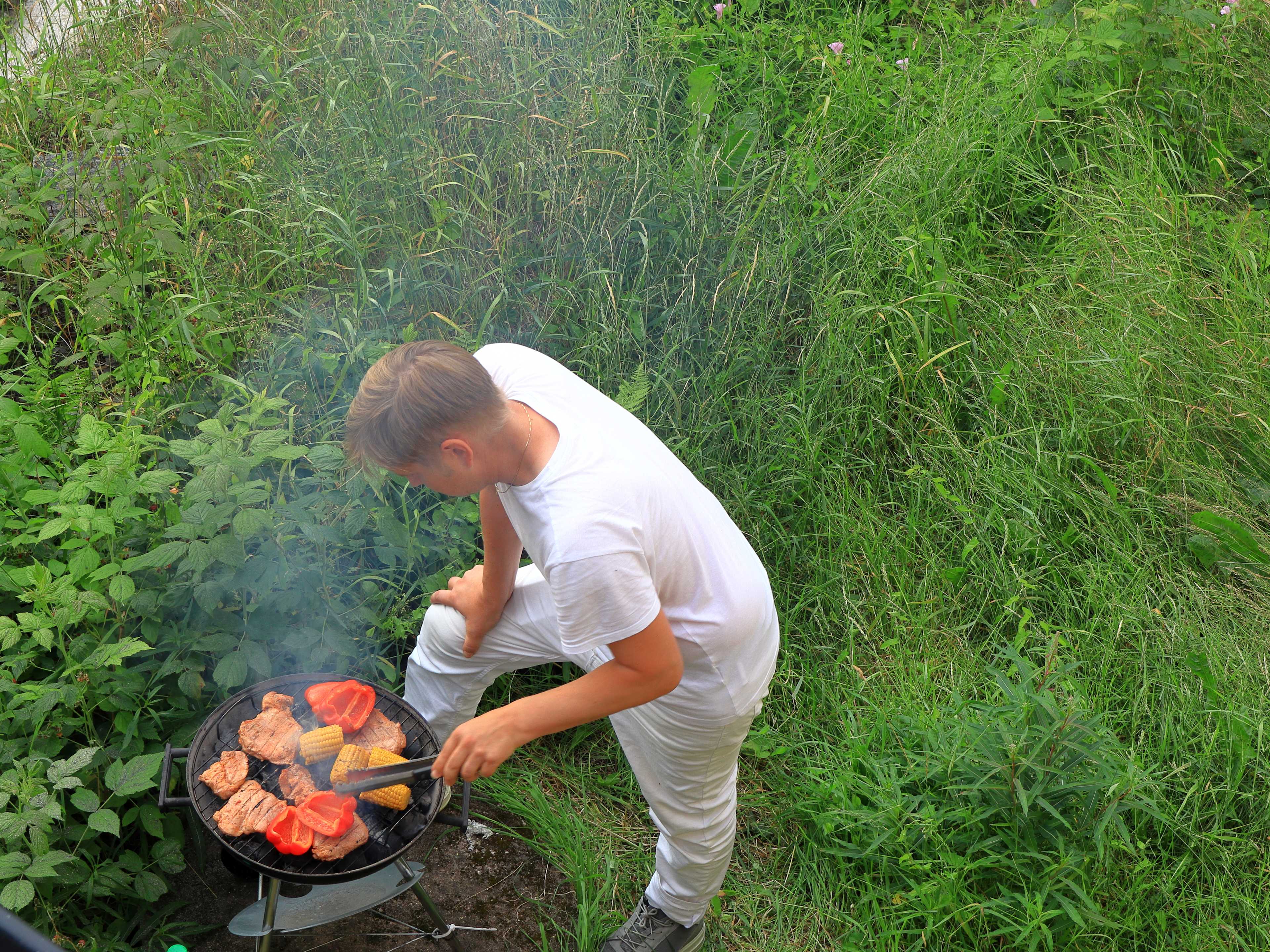 man handling a bbq in a stockholm park