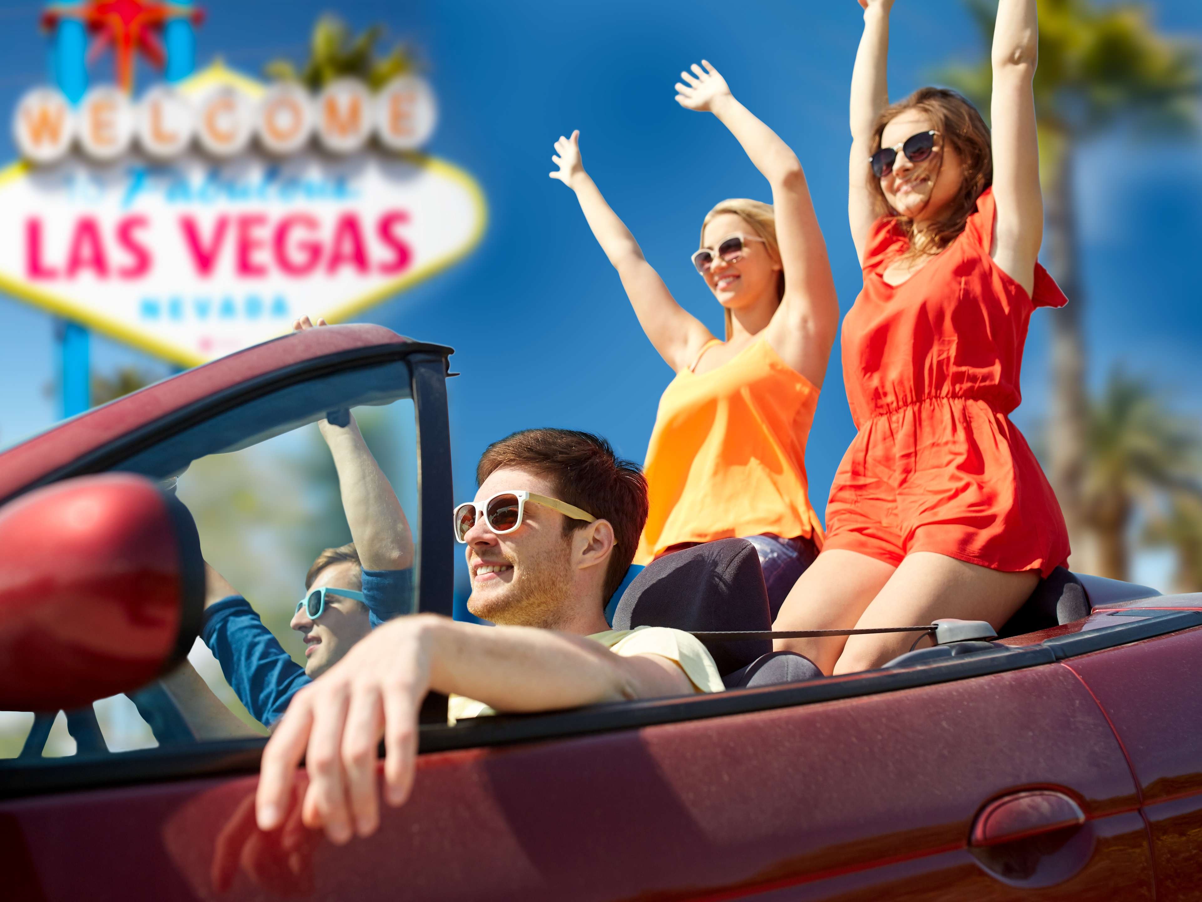 young people enjoying an open-top car ride in vegas