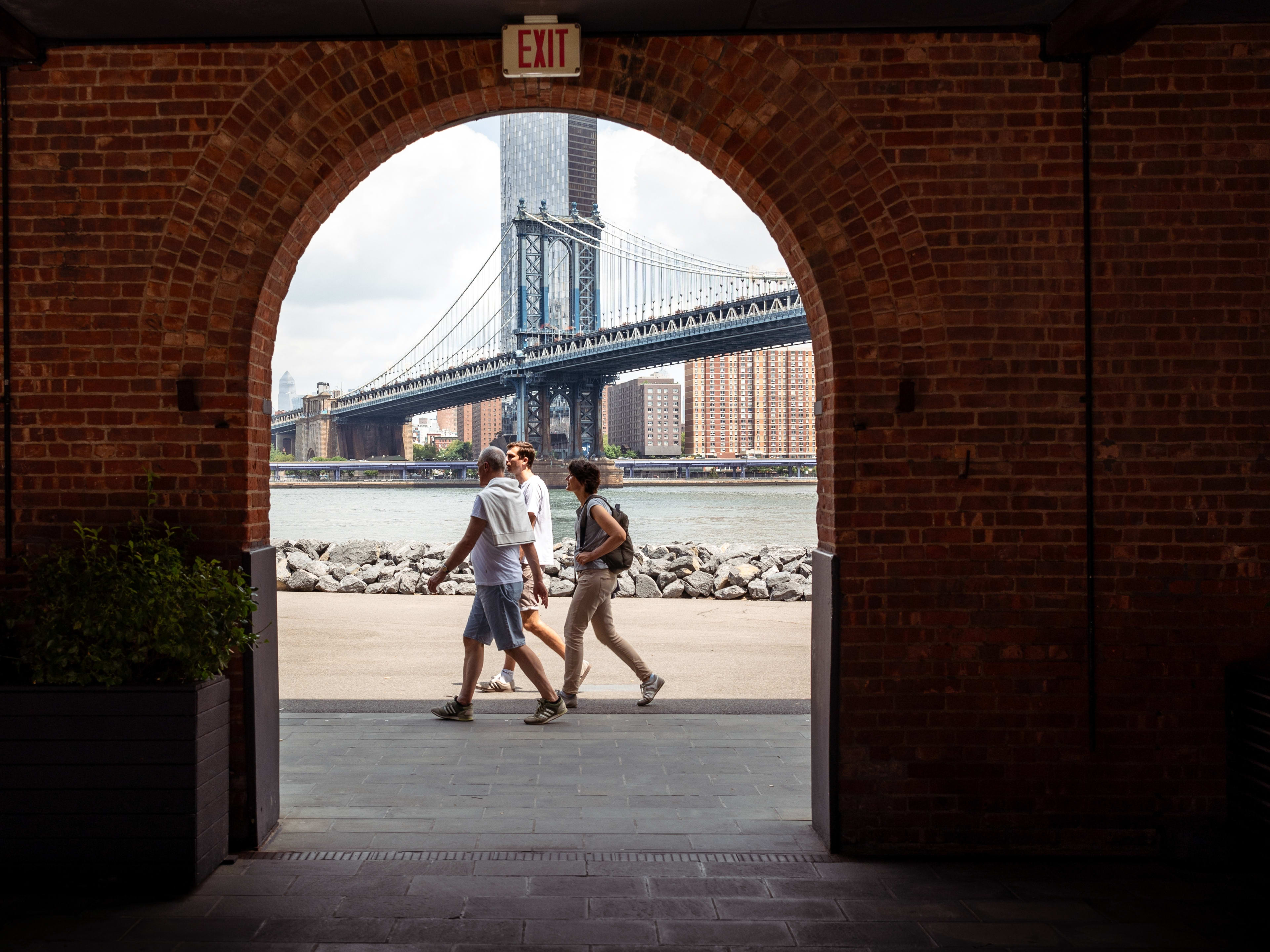 archway with a view of williamsburg bridge in brooklyn, one of the best neighborhoods to check out in the city
