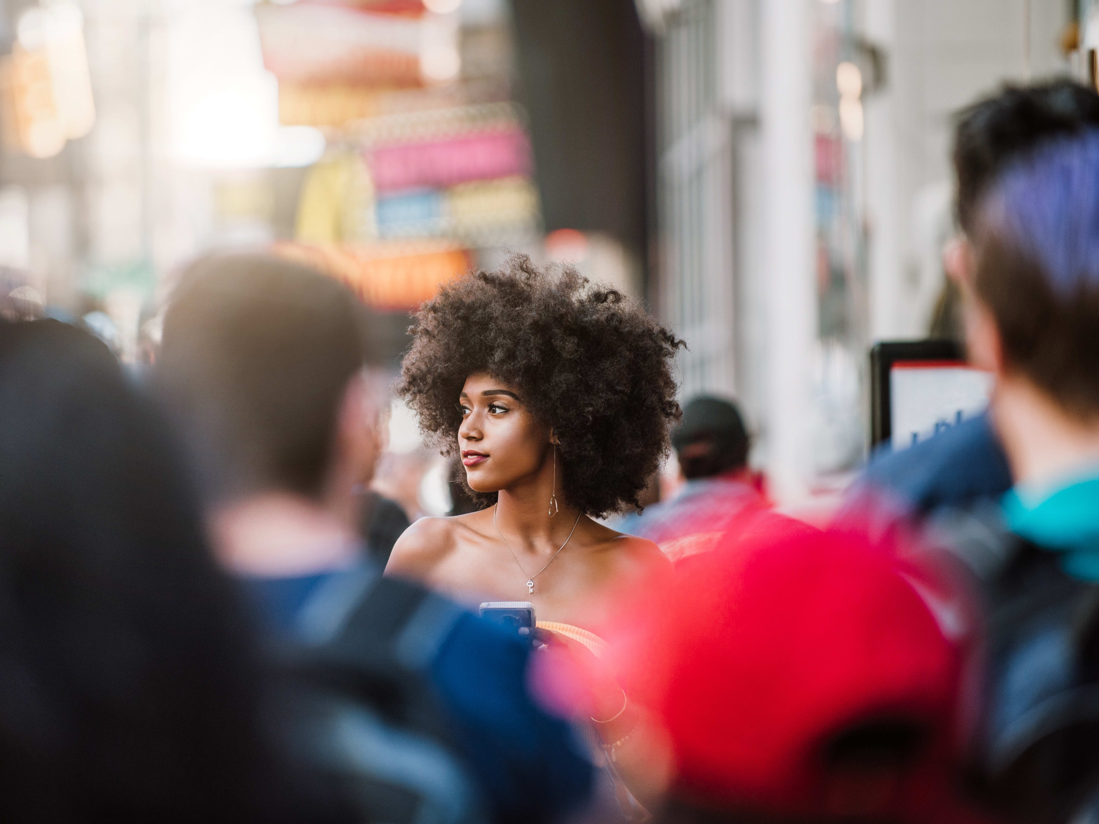woman walking through crowd in NYC