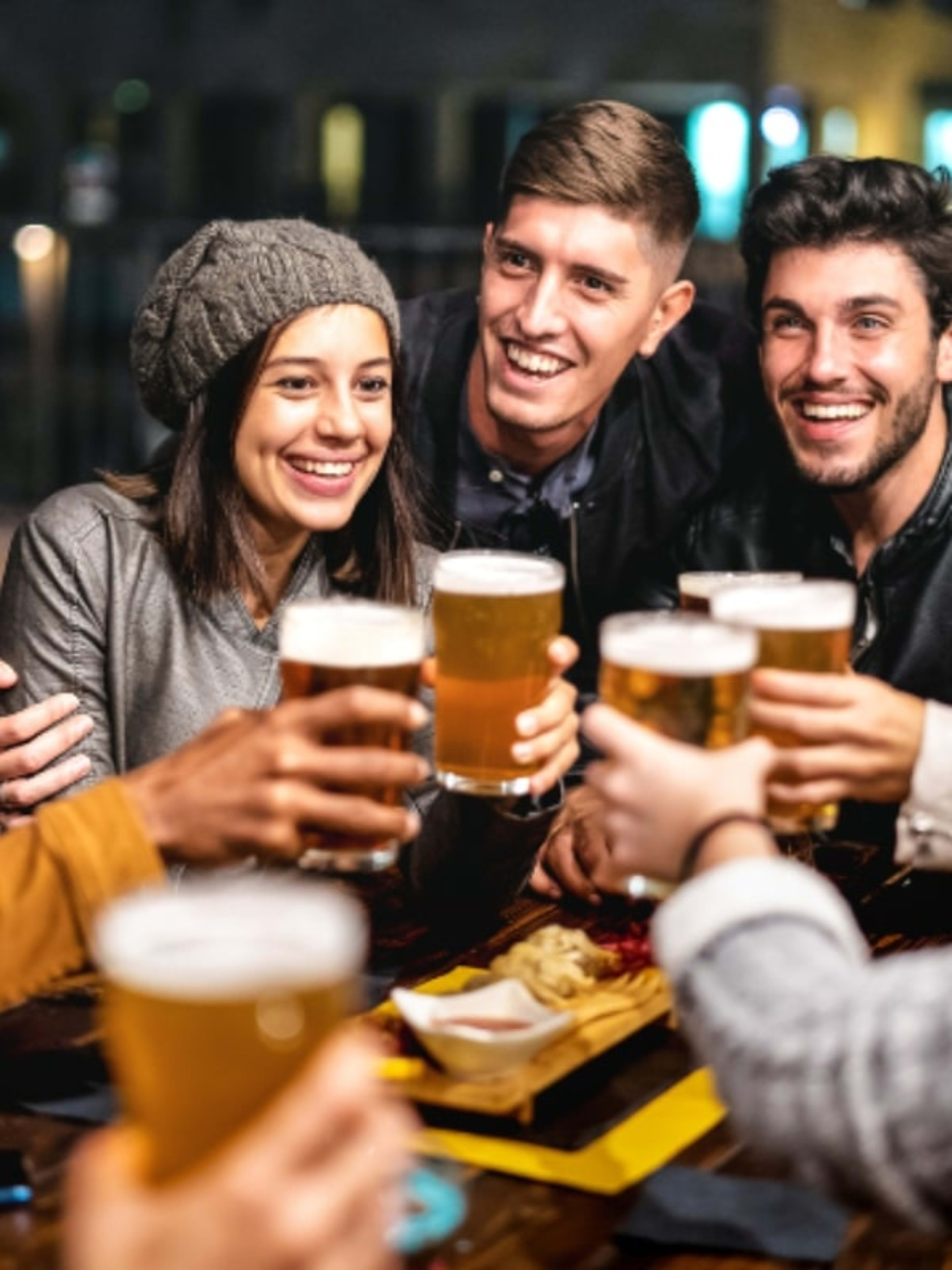 Group of people enjoying drinks in a pub.