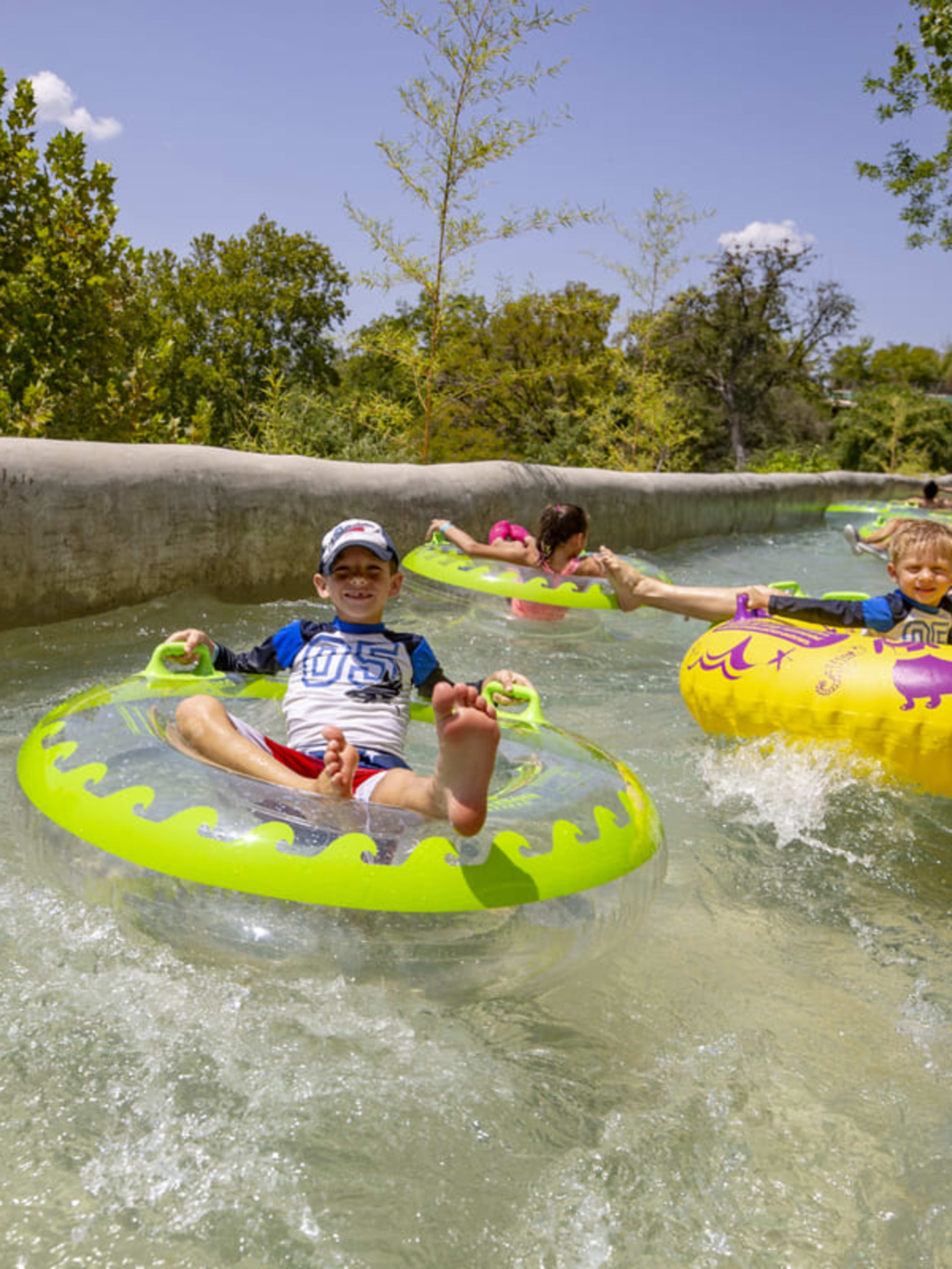 Family on a lazy river at Shlitterbahn Waterpark in New Braunfels, Texas.