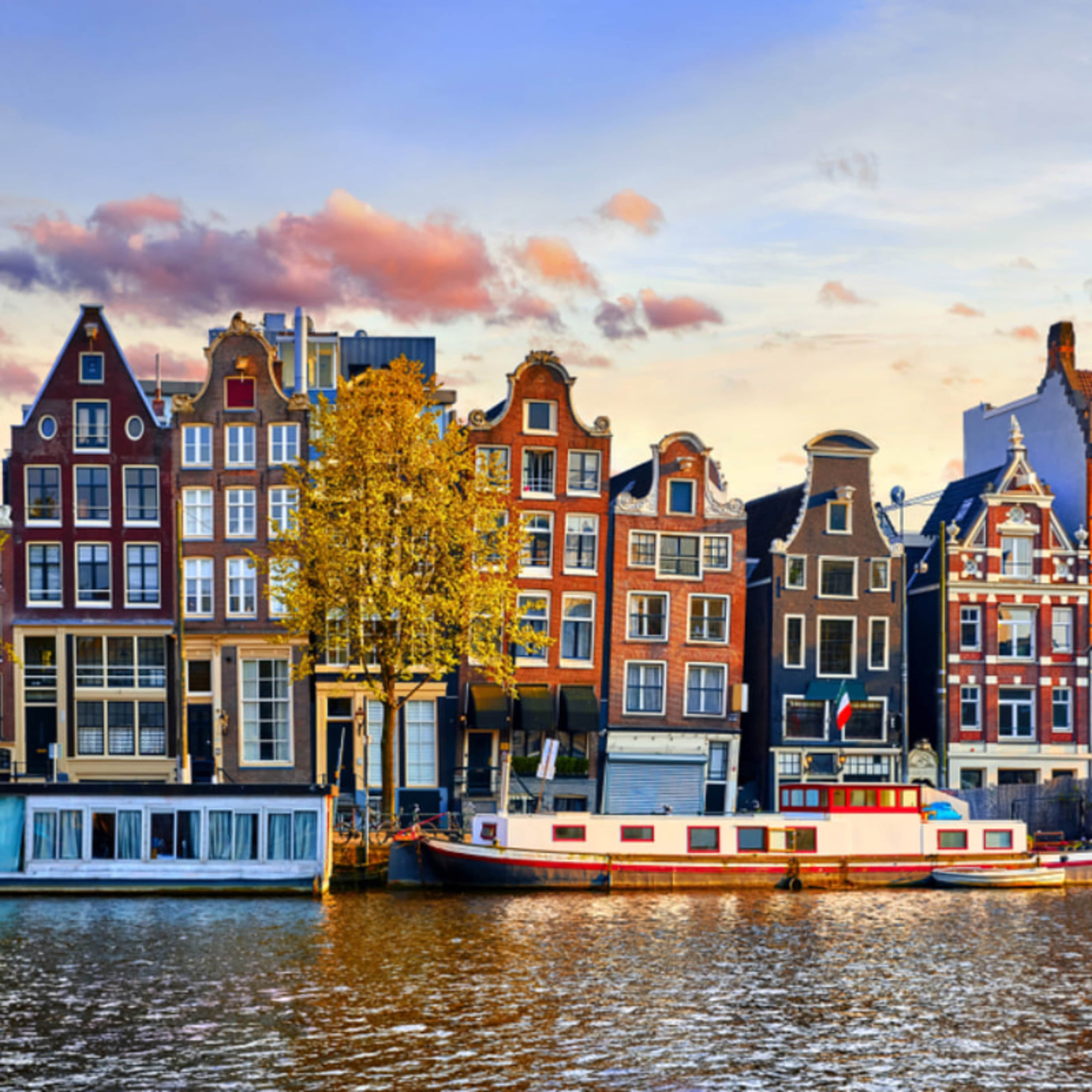 Colorful canal houses lining an Amsterdam canal