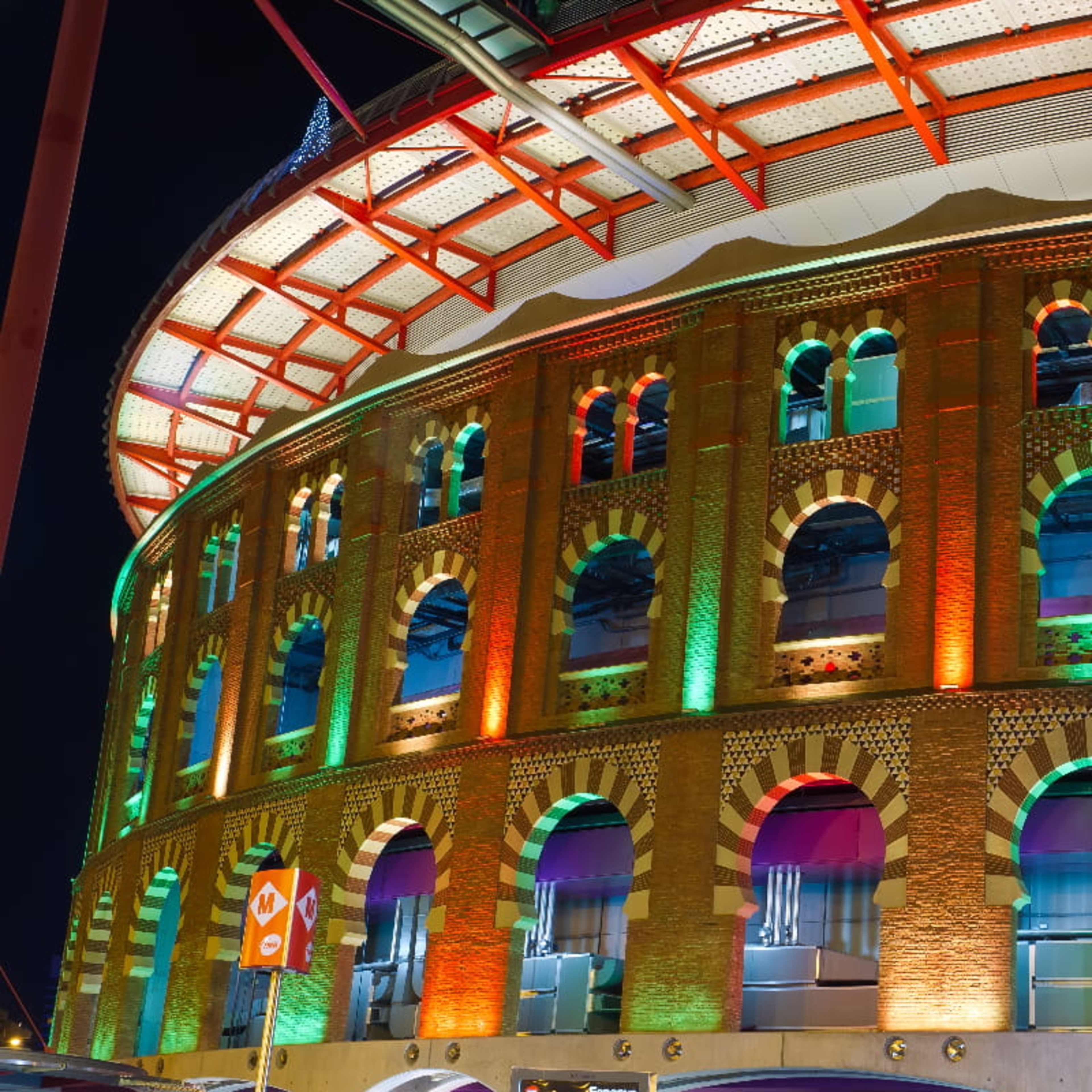 Las Arenas de Barcelona lit up colorfully in the evening